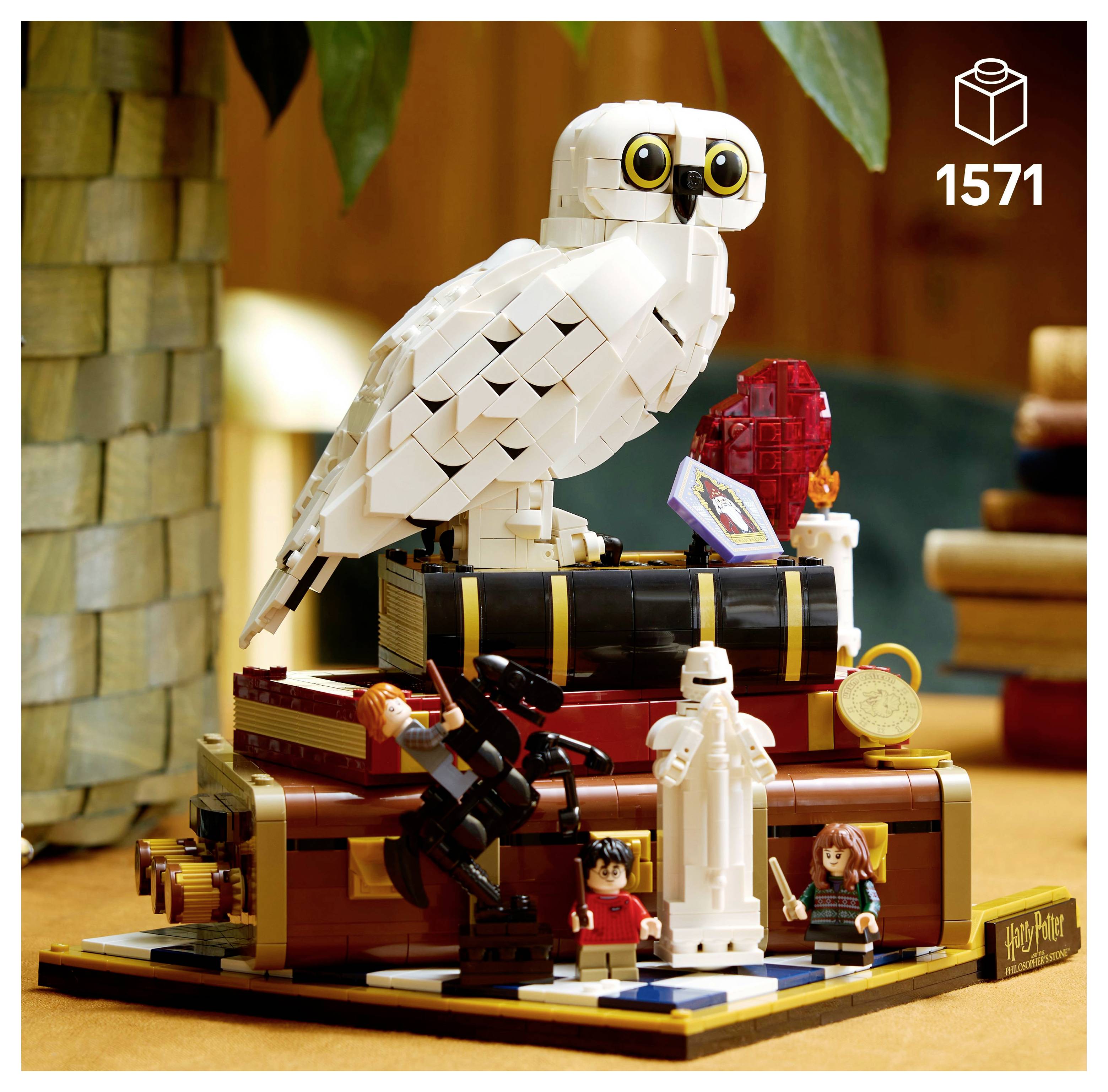 Ensemble Lego représentant un hibou sur une pile de livres avec des personnages tenant des baguettes. La boîte indique 1 571 pièces, sur le thème de 'Harry Potter'