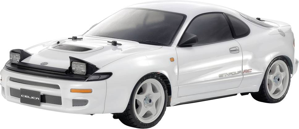 Une voiture miniature blanche d'un véhicule de sport au design élégant et aux phares escamotables, portant l'étiquette 'Celica' dans la zone de la plaque d'immatriculation avant.