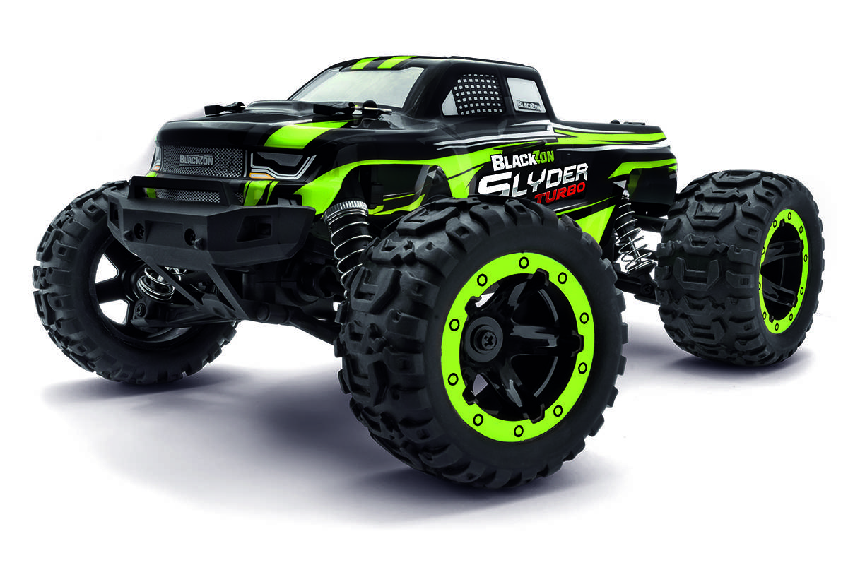 Un camion monstre télécommandé noir et vert avec des roues surdimensionnées, étiqueté 'Blackzon Slider Turbo', positionné en biais.
