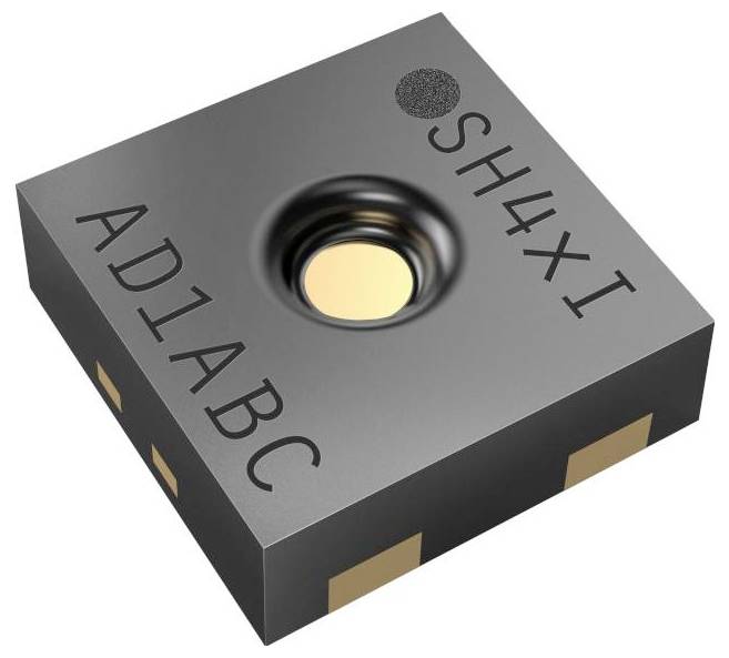« Gros plan d'un petit composant électronique carré étiqueté 'AD1ABC' et 'SH4XI' avec une indentation circulaire sur sa surface supérieure. »