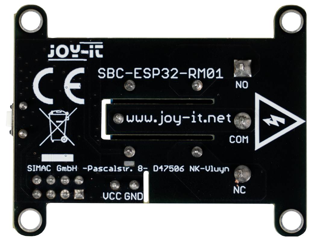 L'image montre l'arrière d'une carte à circuit imprimé Joy-It SBC-ESP32-RM01 avec différentes étiquettes, notamment 'www.joy-it.net' et des étiquettes de ports.