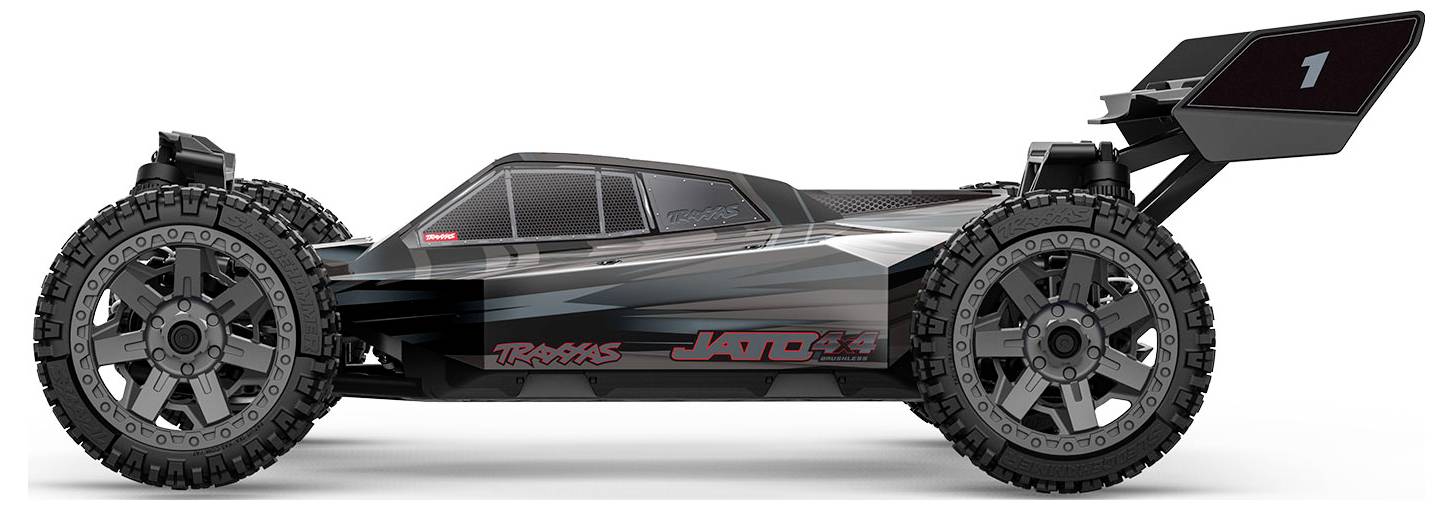 Une voiture télécommandée noire et grise avec de grands pneus robustes et un aileron arrière, portant l'étiquette « Jato 3.3 », vue de côté.