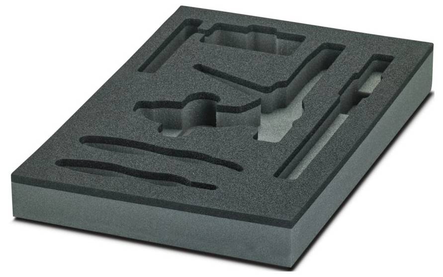 Rectangular black foam with cutouts for storing specific items, seen from an angle. Cutouts vary in shape and depth.