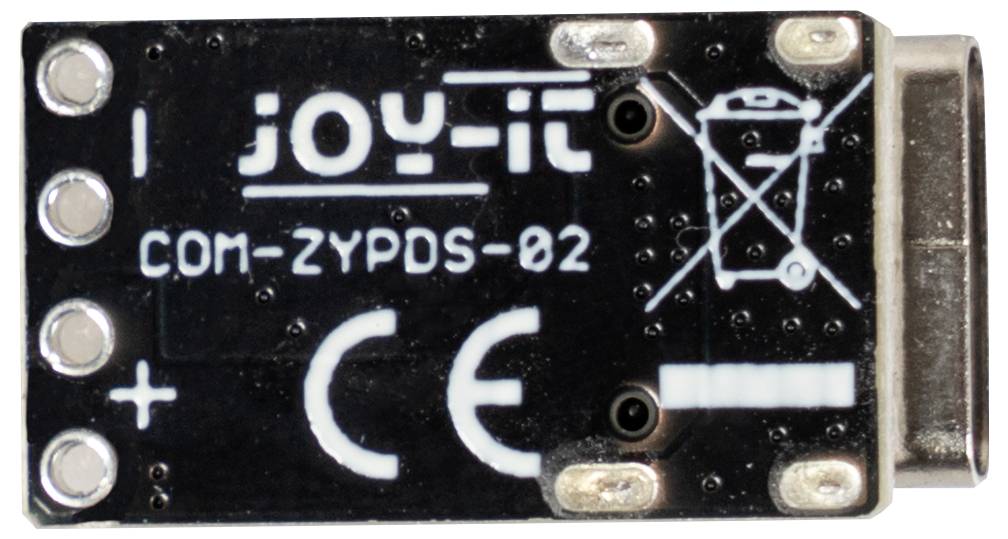 Petit circuit électronique étiqueté 'joy-it COM-ZYPDS-02' avec des symboles indiquant la polarité et des informations sur le recyclage.