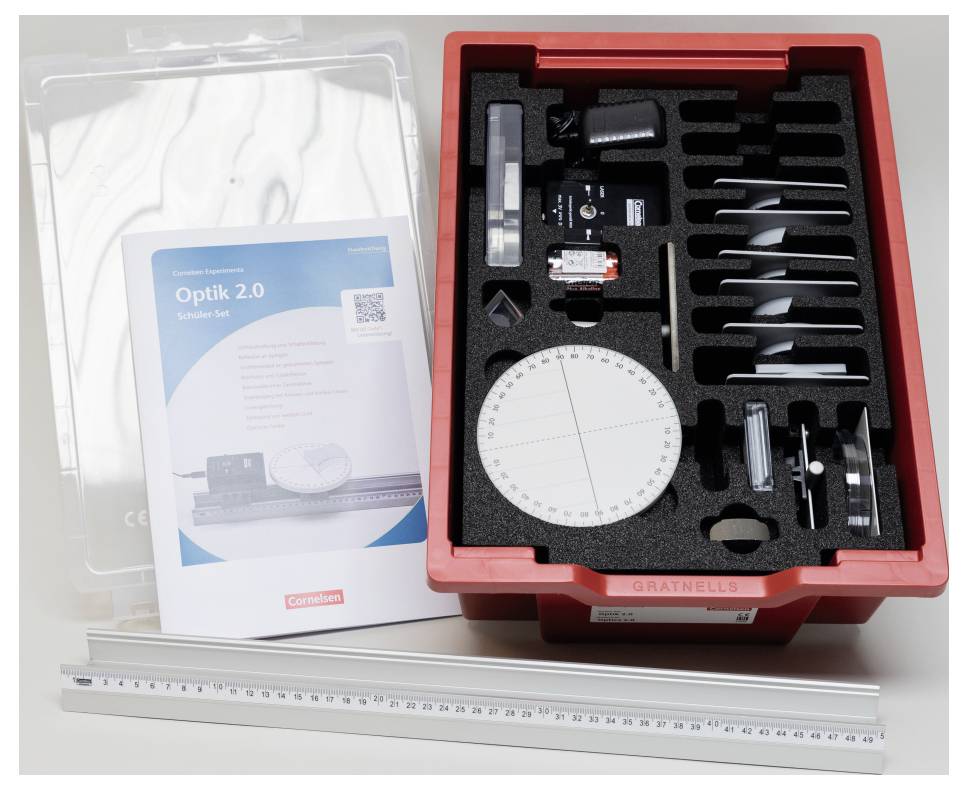 Optics kit with various components in a red case, 'Optik 2.0' manual, and a ruler, designed for educational purposes.