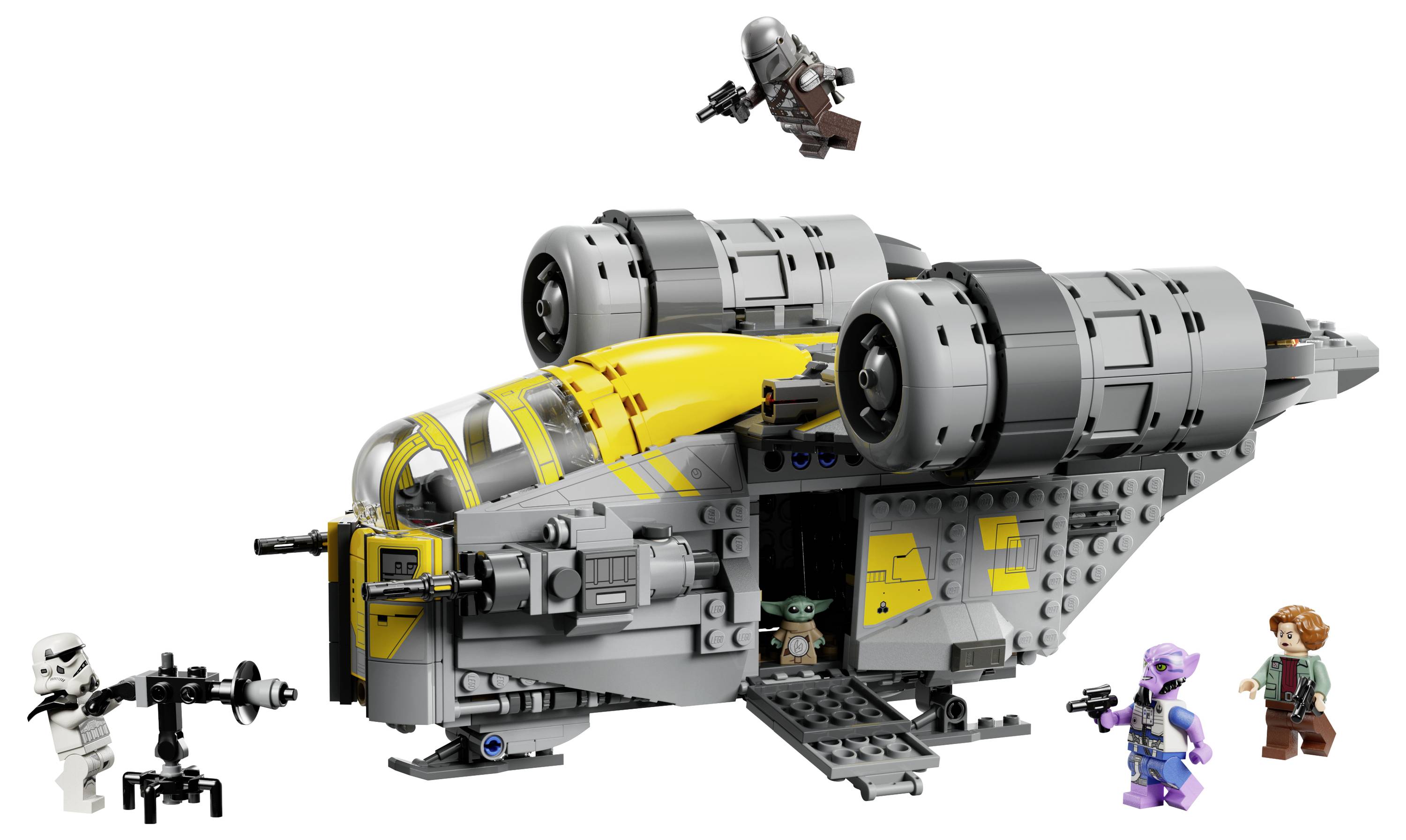Un vaisseau spatial LEGO avec deux grands moteurs, mettant en vedette des personnages de 'Star Wars', y compris une petite figurine verte et d'autres vêtus de différentes tenues.