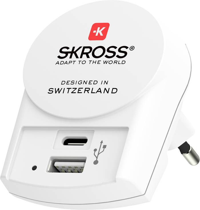 A white SKROSS travel adapter with a USB-C port and an additional USB port, designed in Switzerland, suitable for global use.