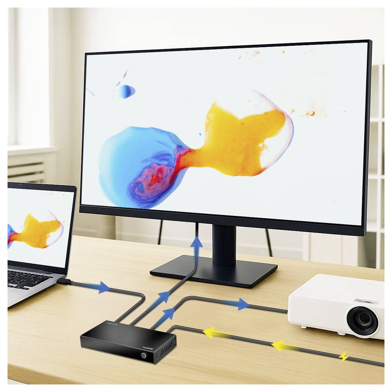A monitor, laptop, and projector are connected to a central hub on a wooden desk. Displayed across the screens is an abstract design.