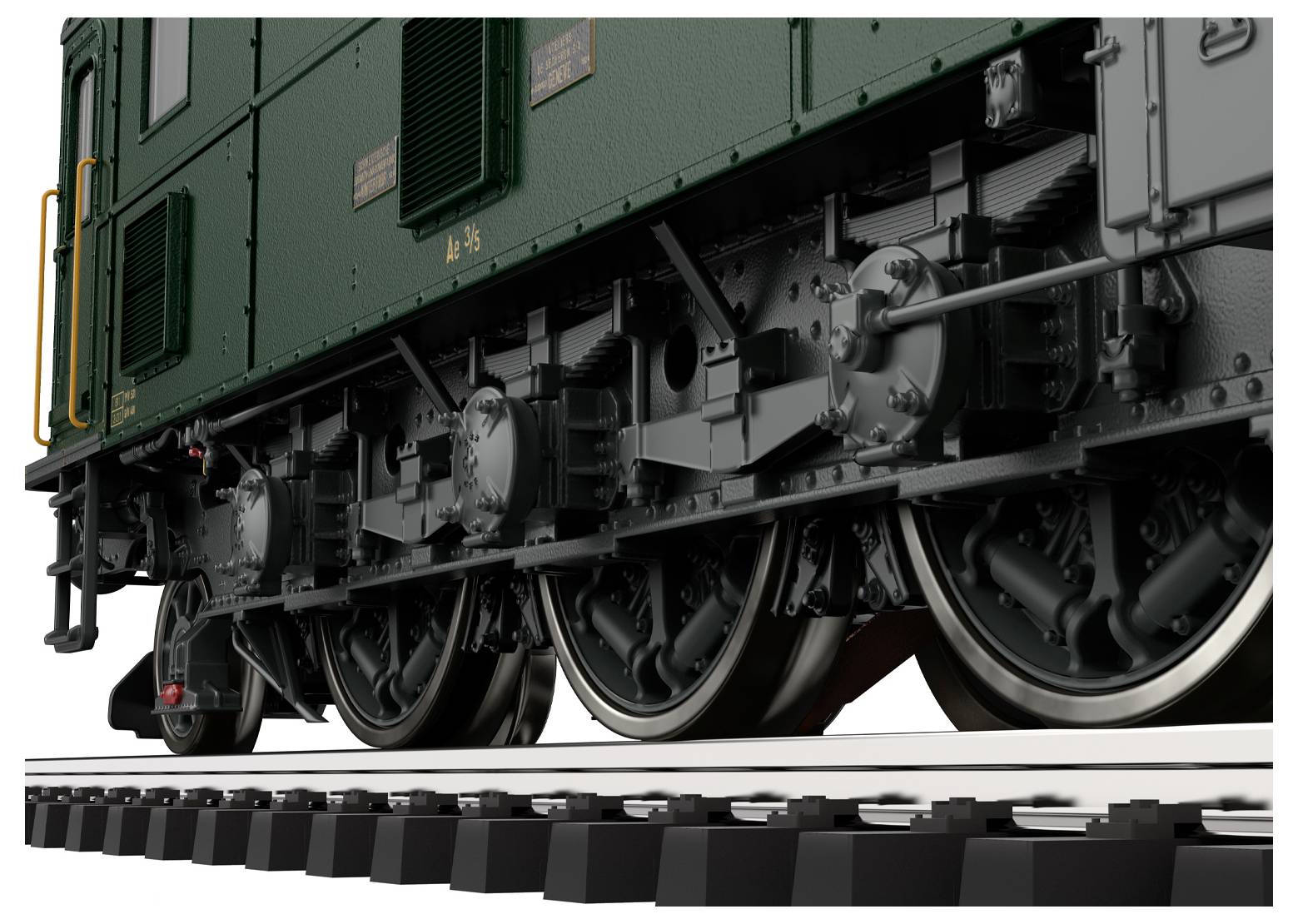 Vue rapprochée de la moitié inférieure d'une locomotive verte, montrant en détail les roues et les mécanismes sur les rails.