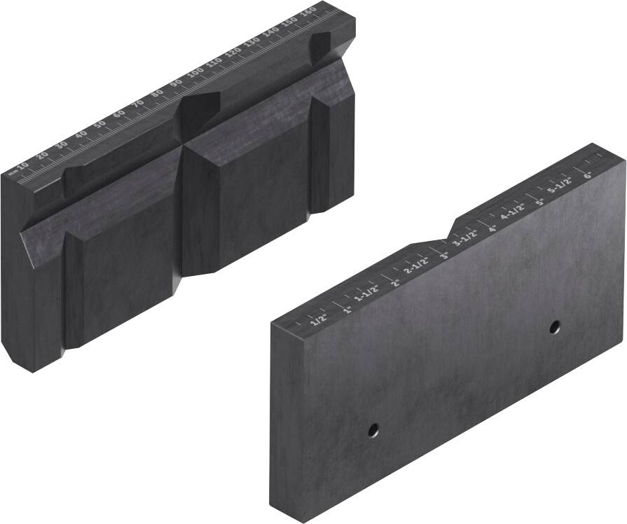 Two precision metal tool parts, one with multiple ridges and markers, another smooth with hole indents, likely machine component parts.