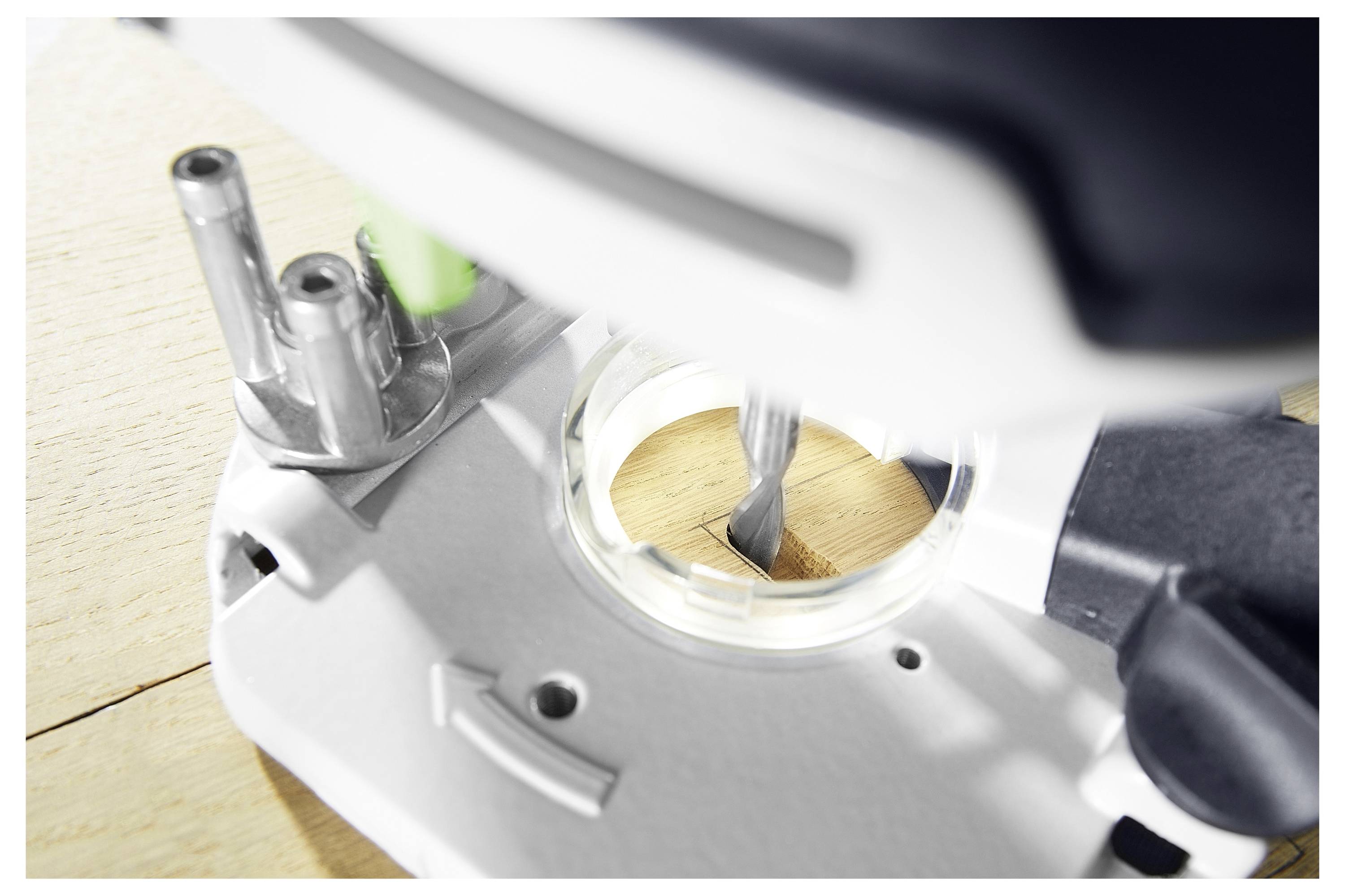 Close-up of a drill creating a hole in a wooden surface, focusing on the precision and action of the drill bit engaging with the wood.