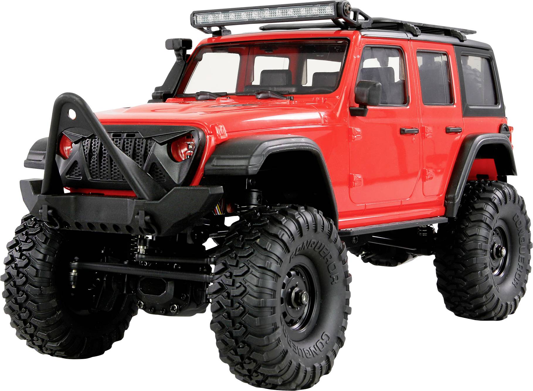 Un véhicule tout-terrain rouge à quatre portes avec de grands pneus robustes et un pare-chocs avant proéminent, conçu pour les terrains difficiles.