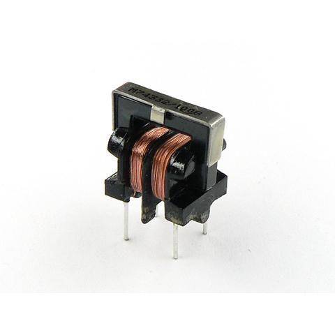 A small electronic component with copper coils and metal pins, likely an inductor, on a white background.