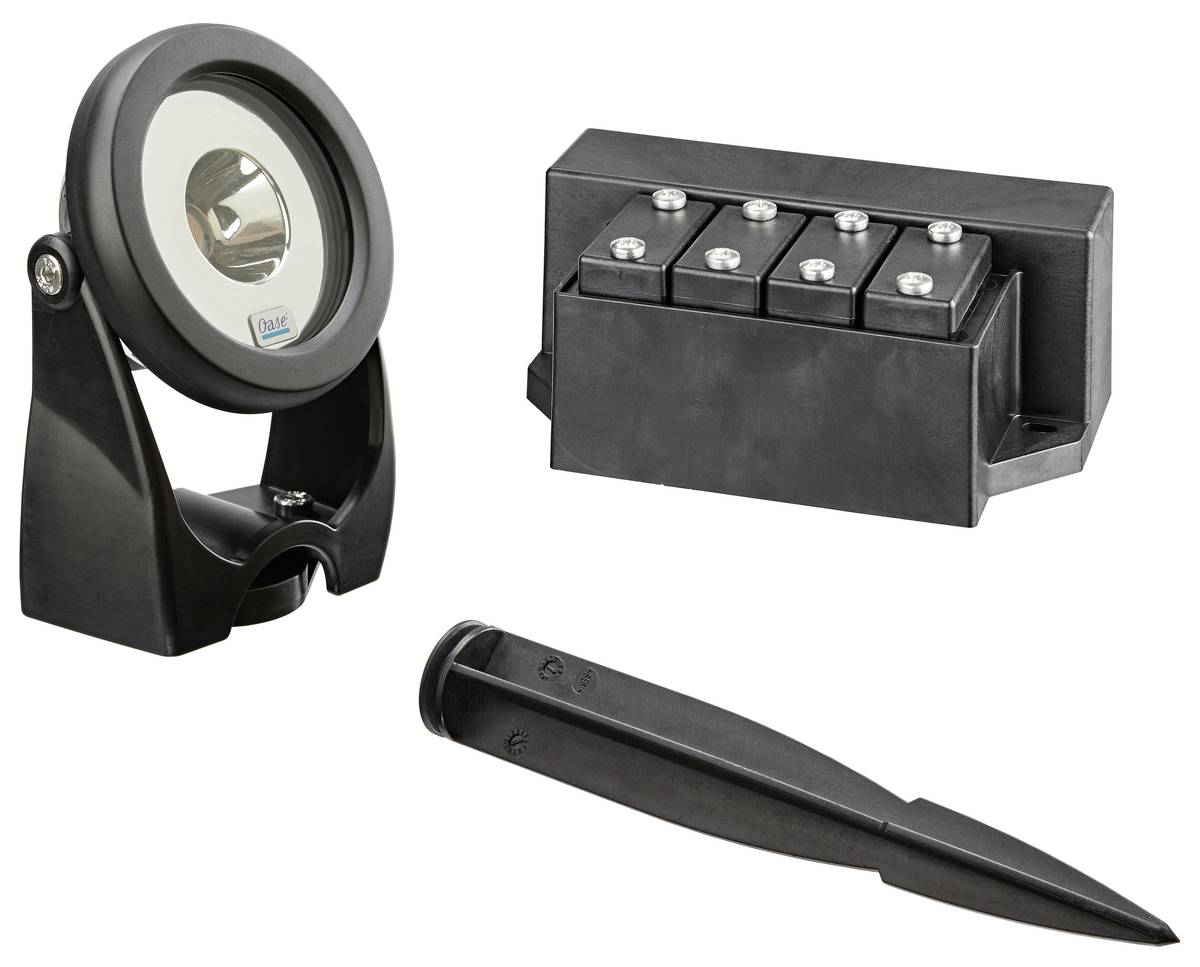 Set of black garden light accessories: a spotlight, a four-socket connector block, and a ground stake on a white background.
