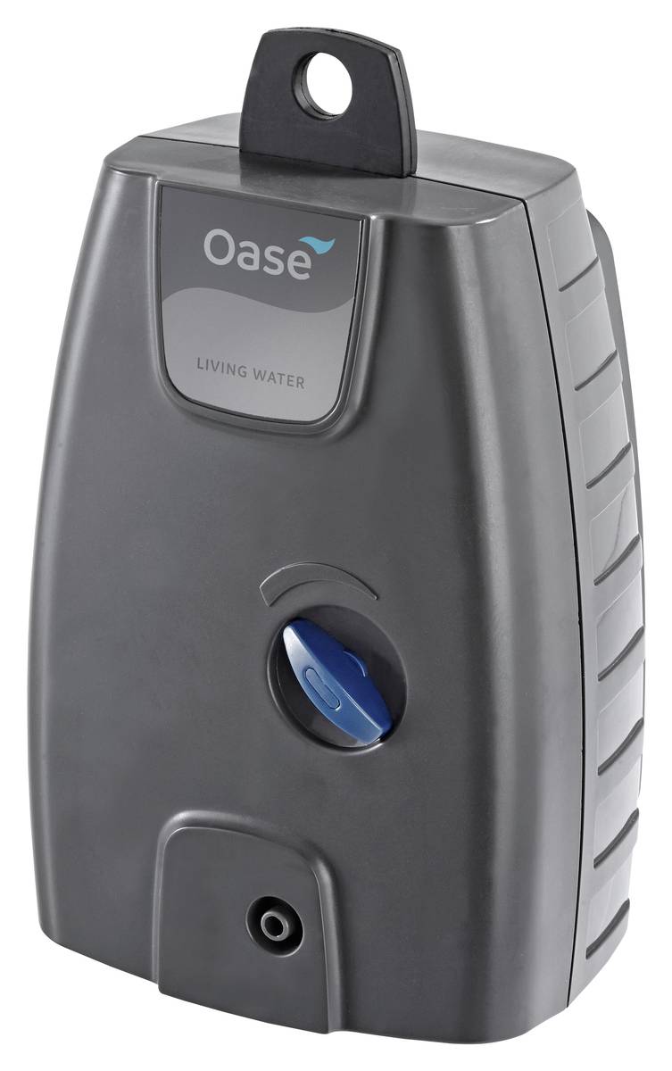 Gray Oase Living Water device with top hanging tab, front viewing window, blue control knob, and bottom outlet