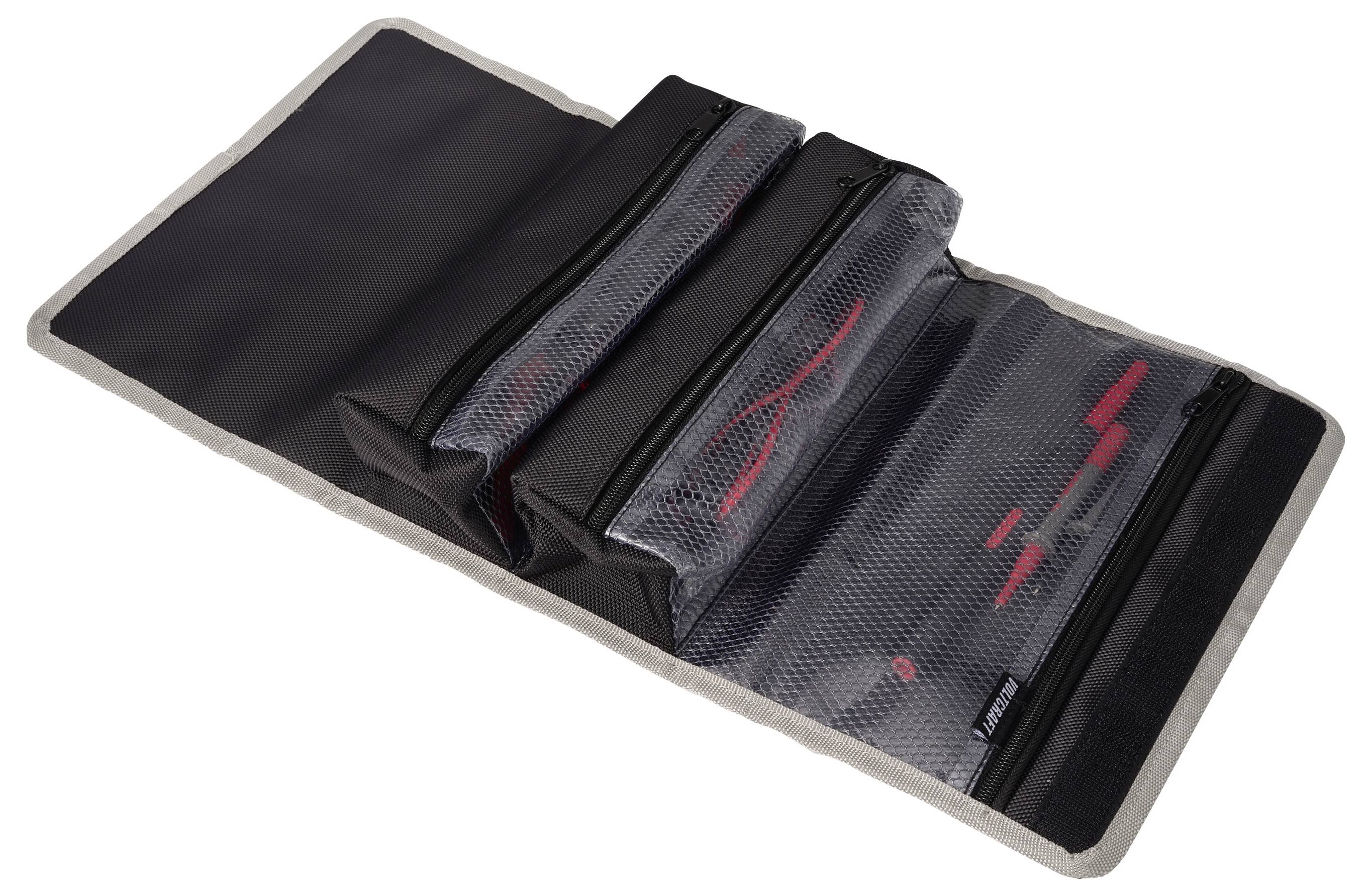 Black folding organizer mat with three zippered mesh pockets on a gray-backed base.