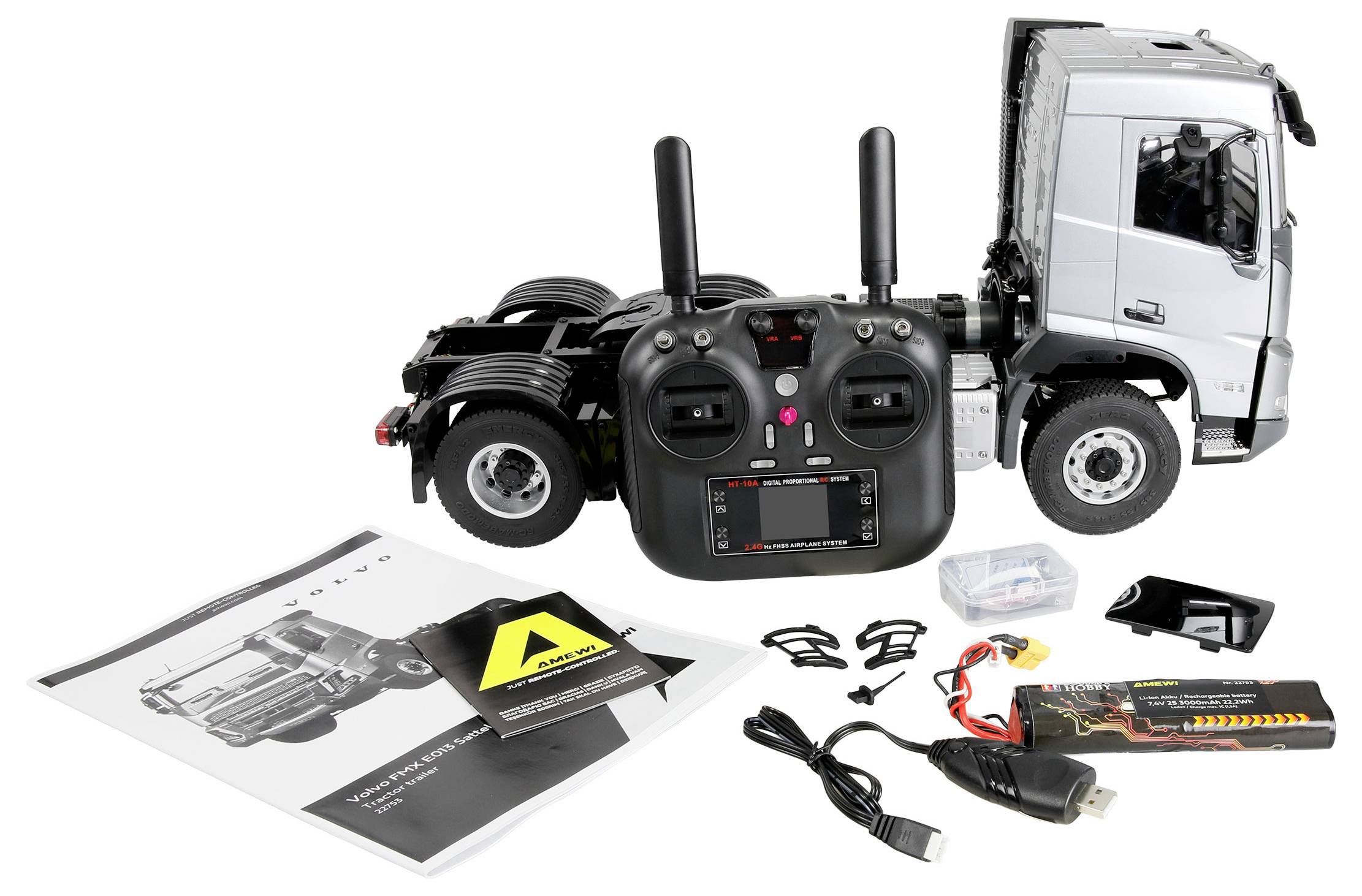 Kit de modèle de camion télécommandé avec télécommande, manuel d'instruction, chargeur et petites pièces d'assemblage affichés sur un fond blanc