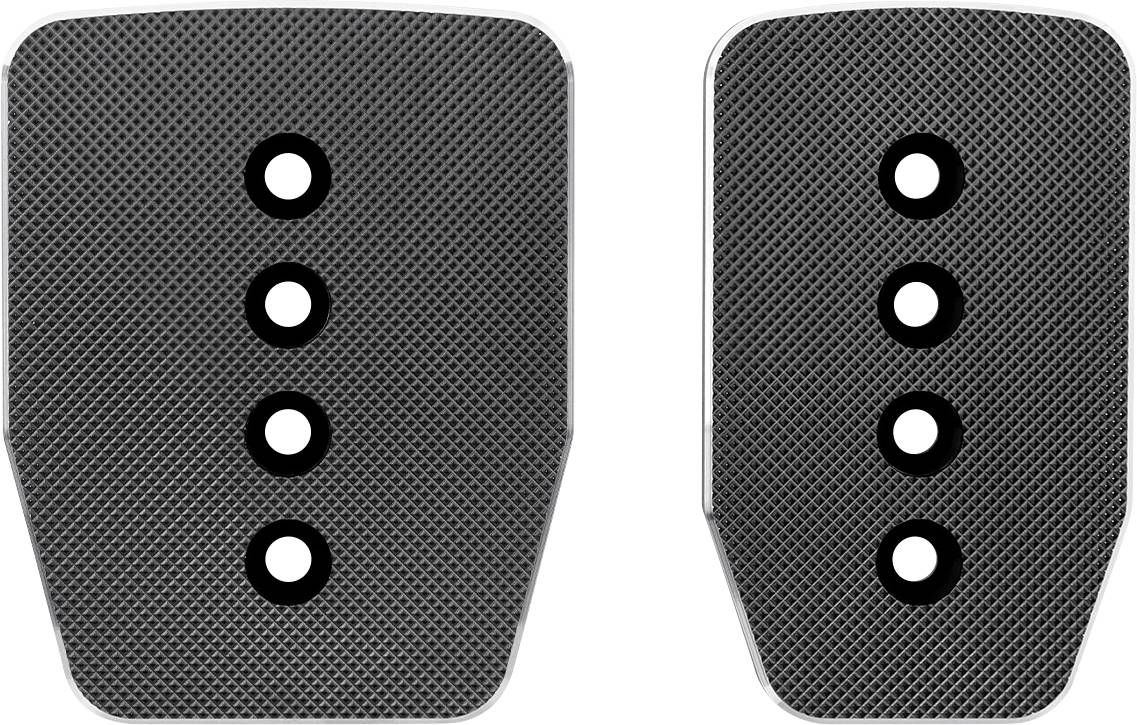 Deux plaquettes de pédales texturées noires avec quatre trous de montage chacune, présentées côte à côte sur un fond blanc.