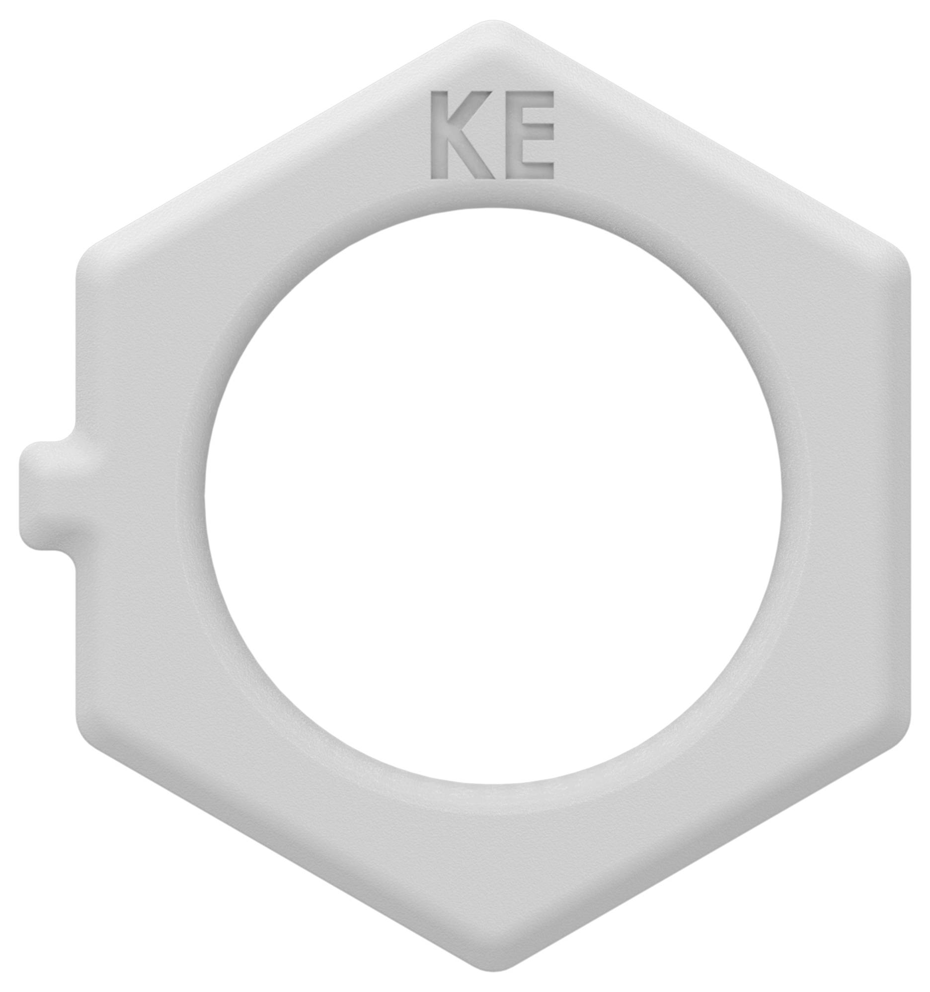 Anneau hexagonal en plastique gris avec un large trou central et les lettres « KE » en relief en haut, ressemblant à un écrou ou un bouchon.