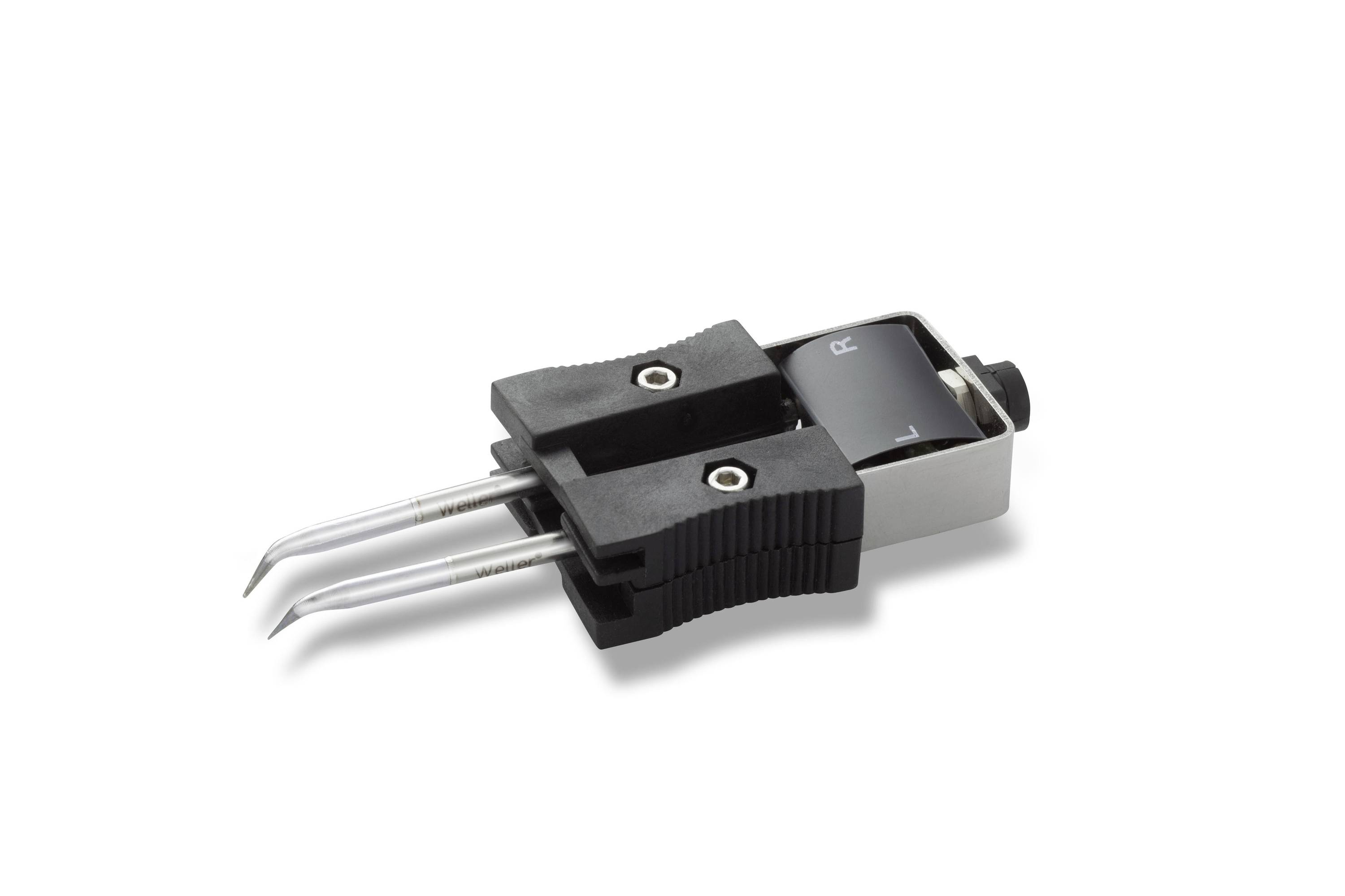 Close-up of a black and silver turntable cartridge with stylus and two metal contact pins on a white background.