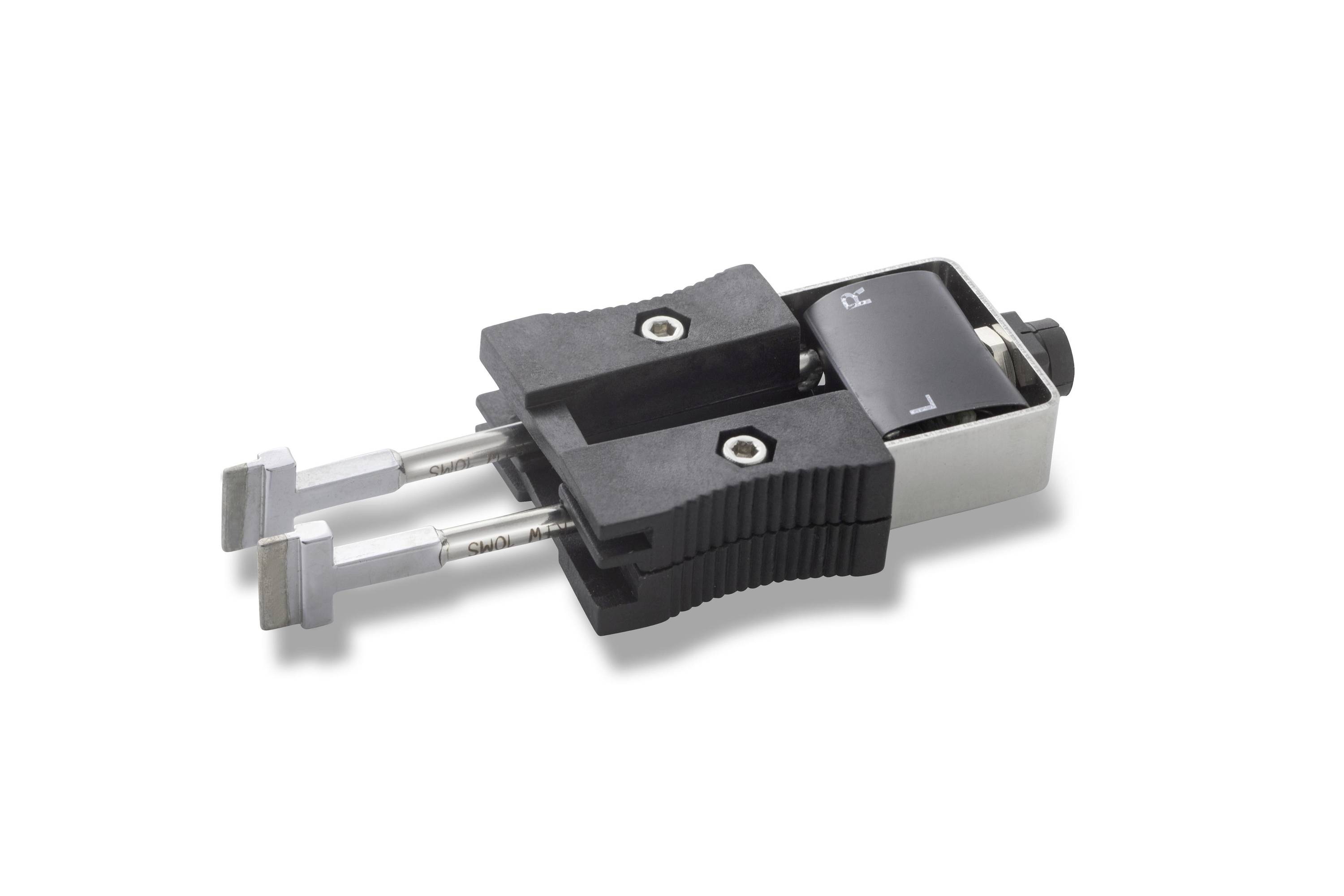 Close-up of a two-prong electrical plug adapter with retractable blades in a black and silver plastic housing.