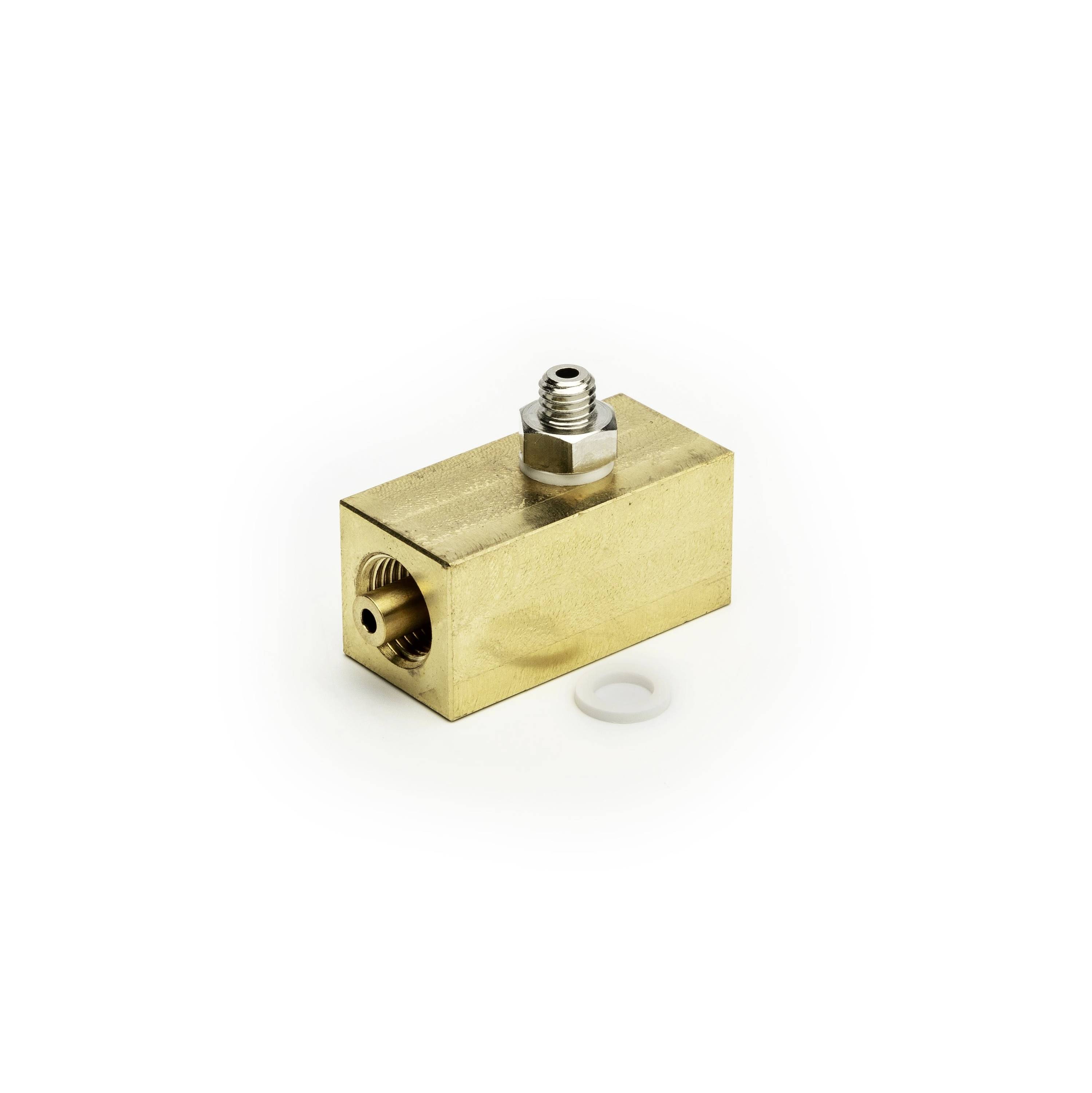 Brass rectangular fitting block with threaded ports, shown on a white background.