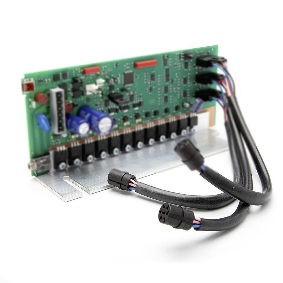 Green circuit board with electronic components and multiple attached wiring harness connectors on a metal bracket, shown on a white background.