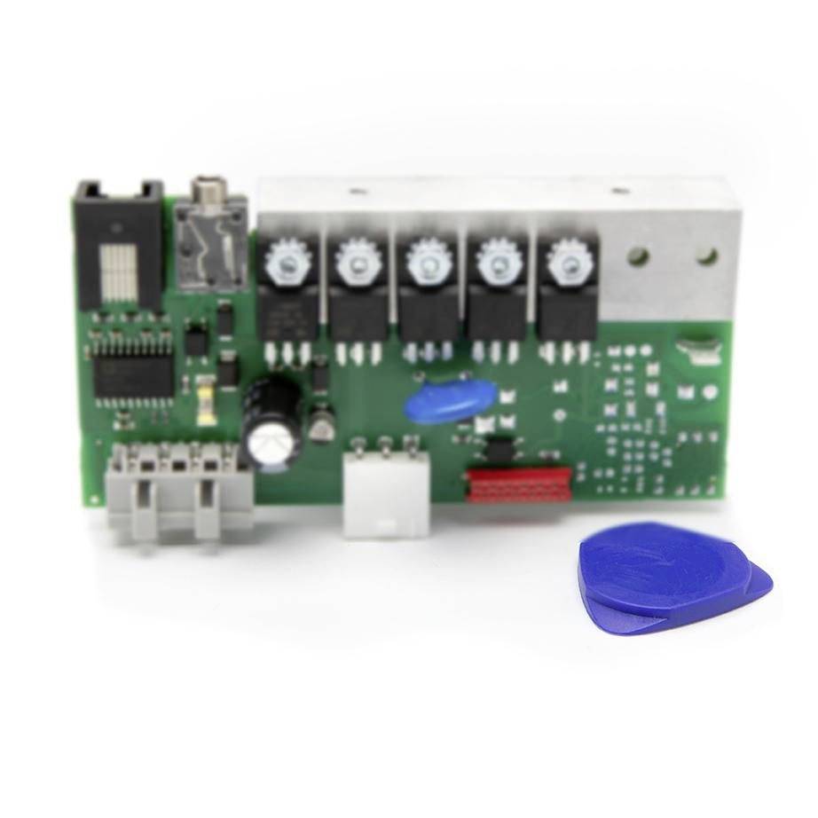 Green printed circuit board with black components and connectors, shown with a blue plastic pry tool on a white background.