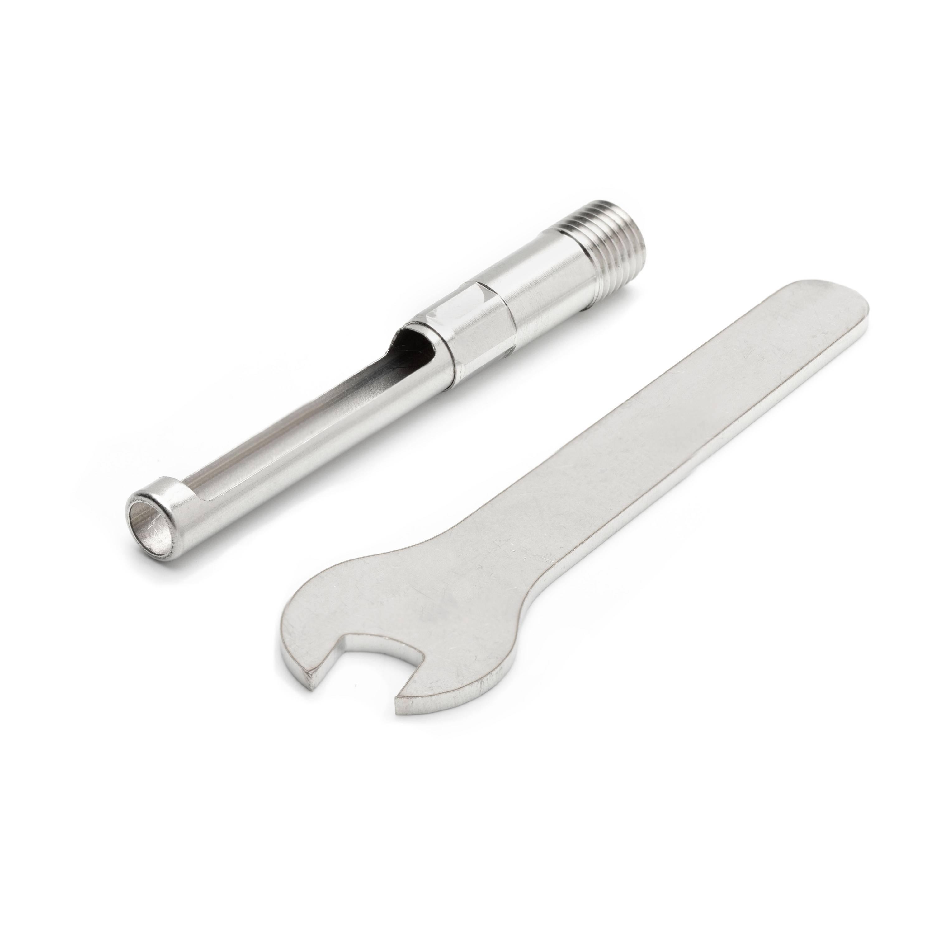 Metal pipe fitting and open-end wrench on a white background.