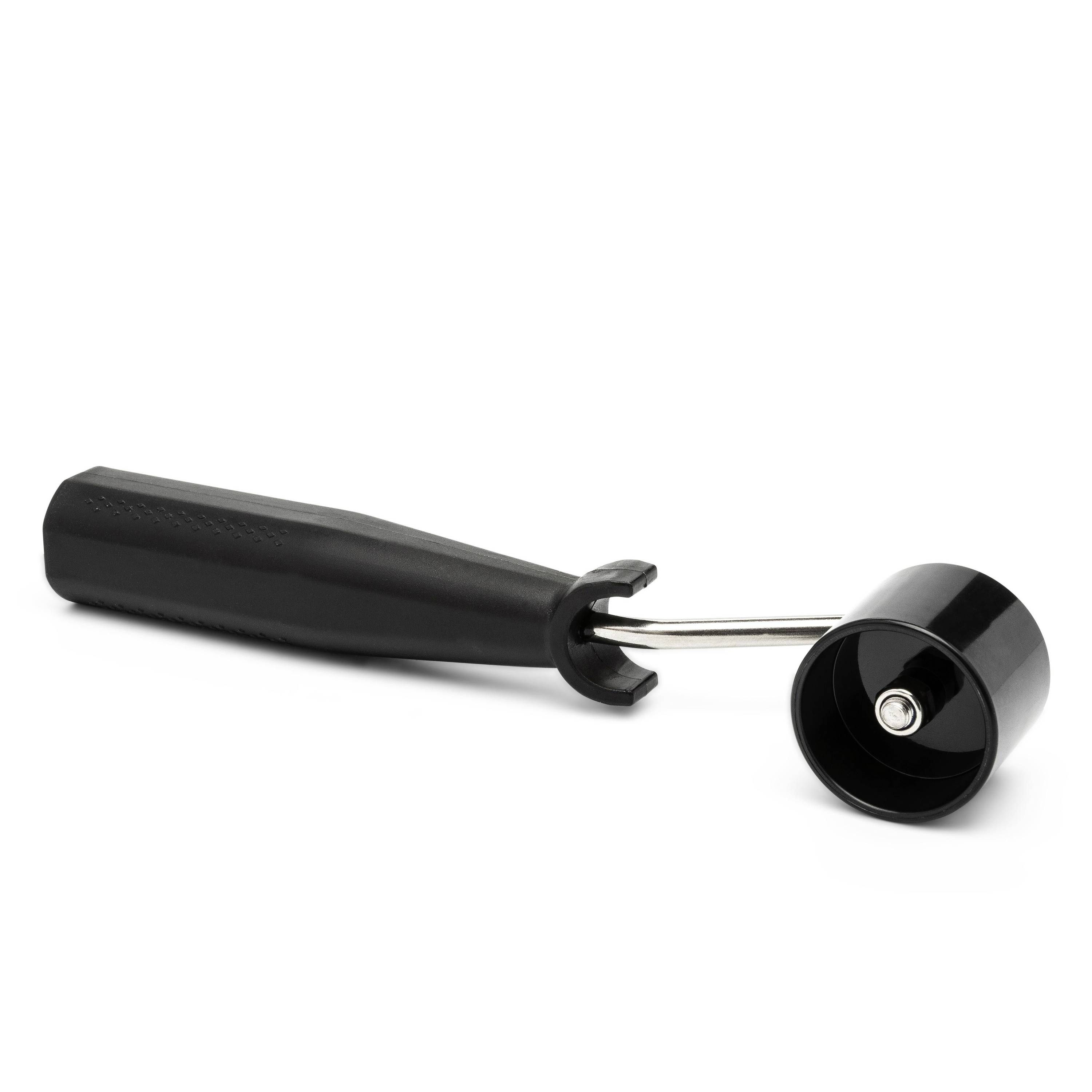 Black-handled metal jar opener with a clamp end and round wheel, shown on a white background.