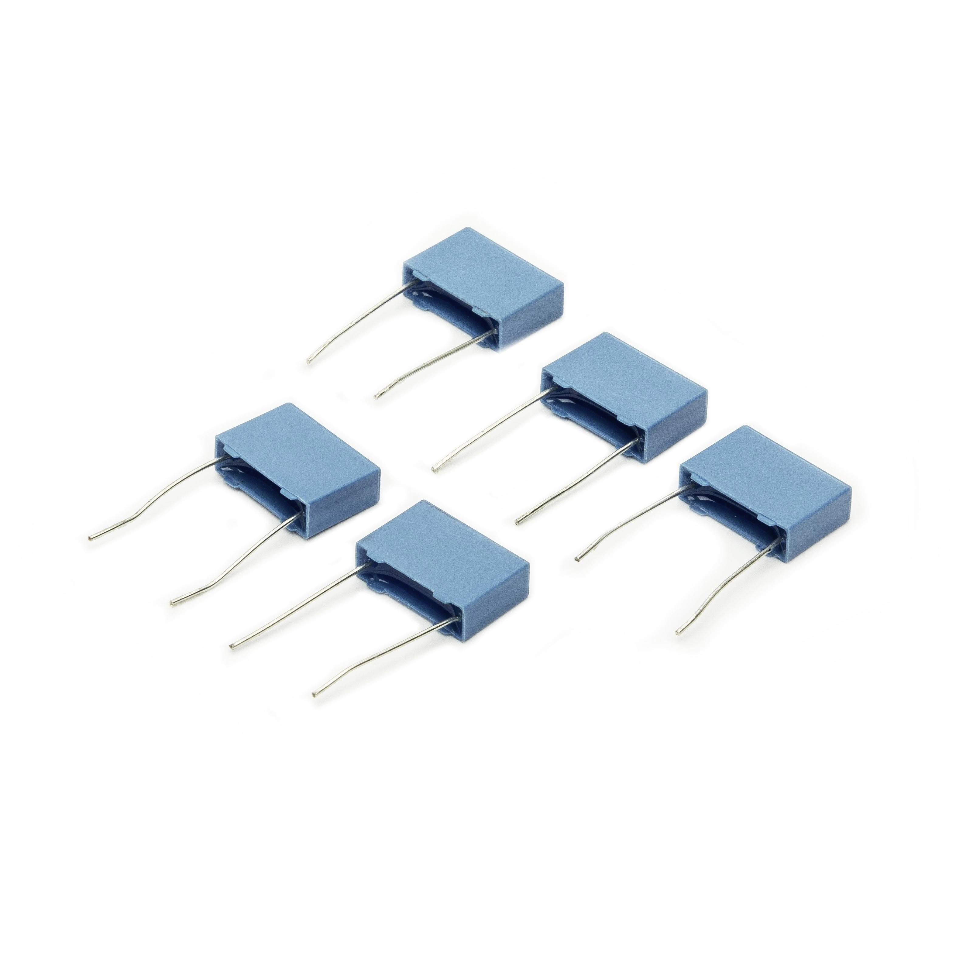 Five blue rectangular electronic components with two wire leads each, arranged on a white background.