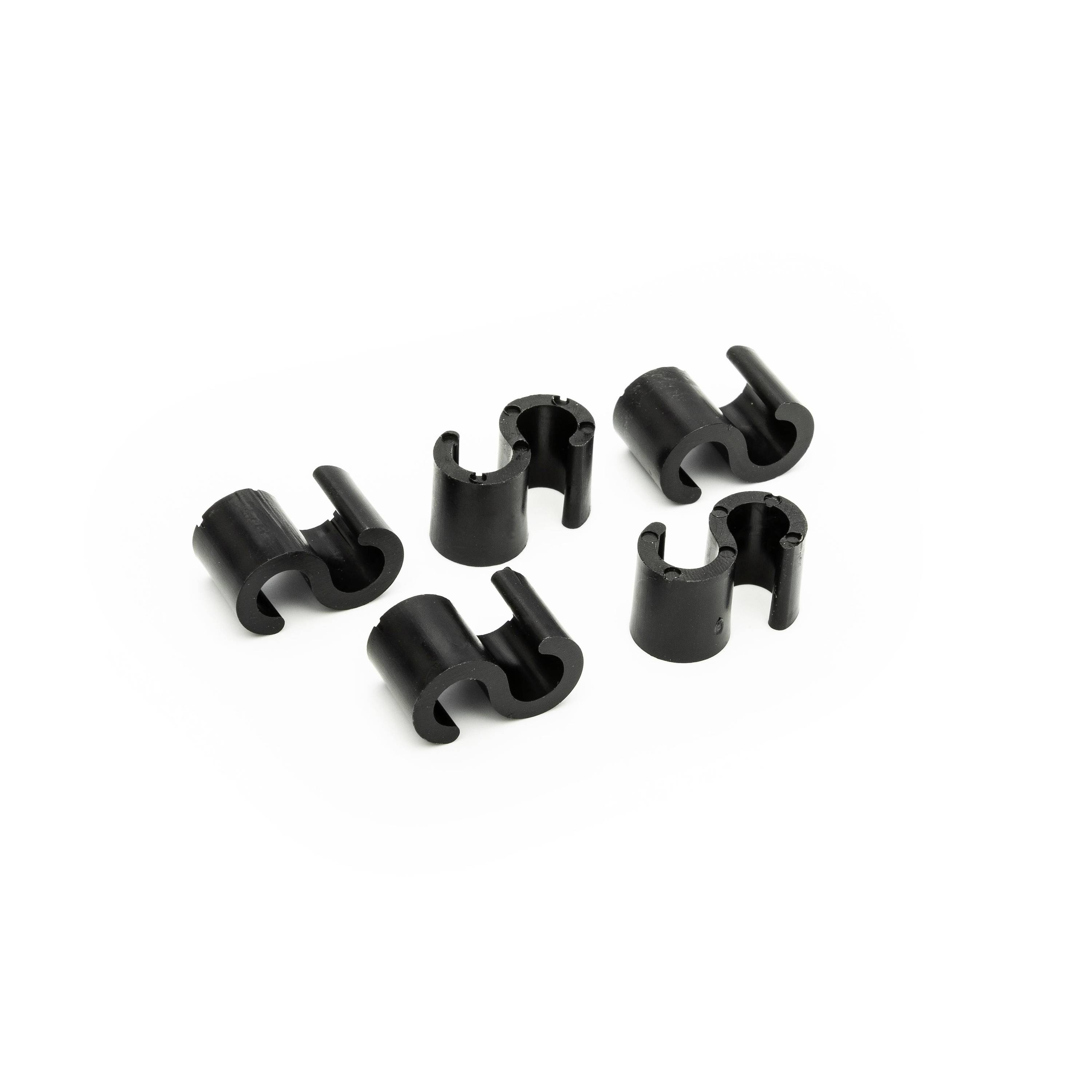Five small black plastic cable clips arranged on a white background.