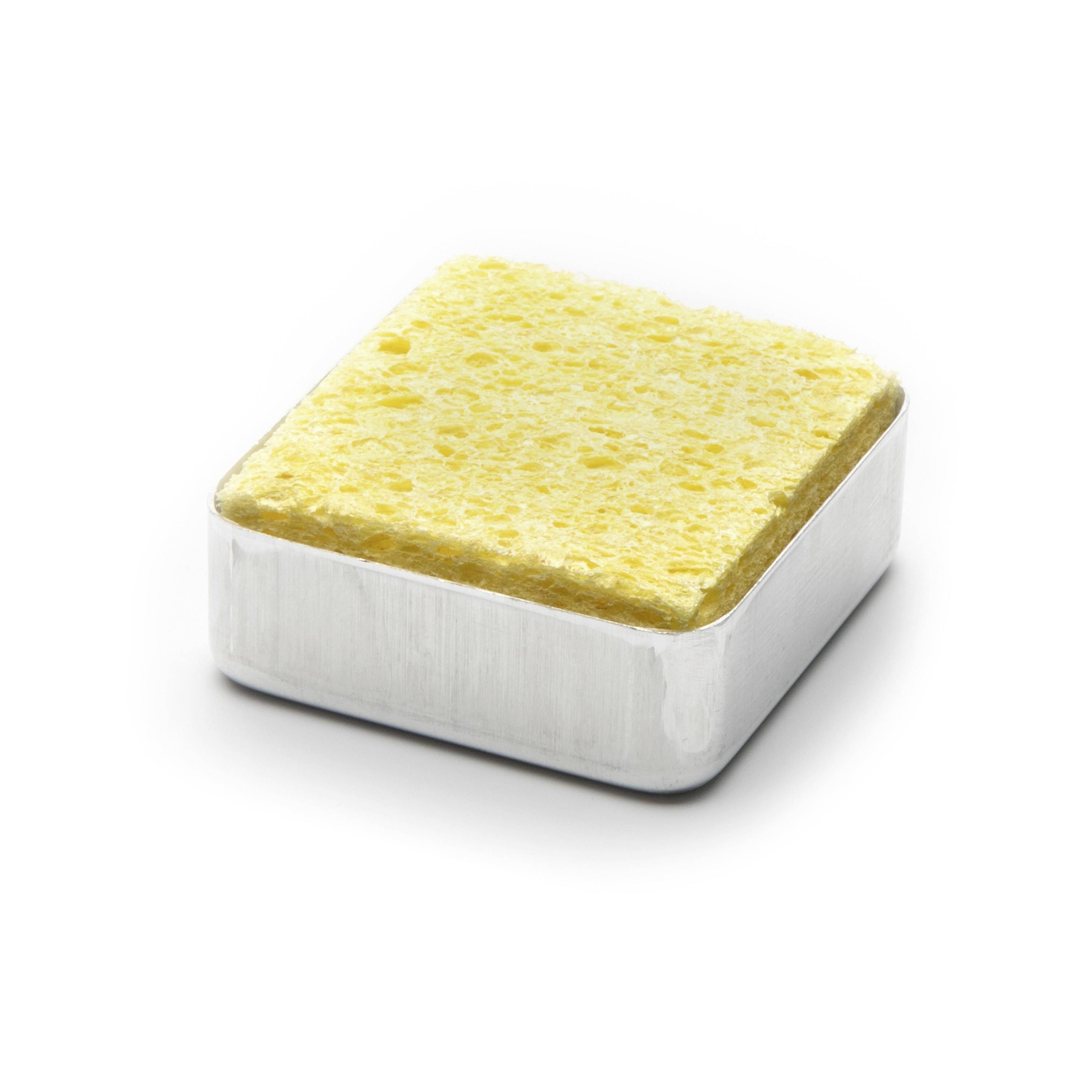 Square yellow sponge cake in a silver metal baking pan on a white background.