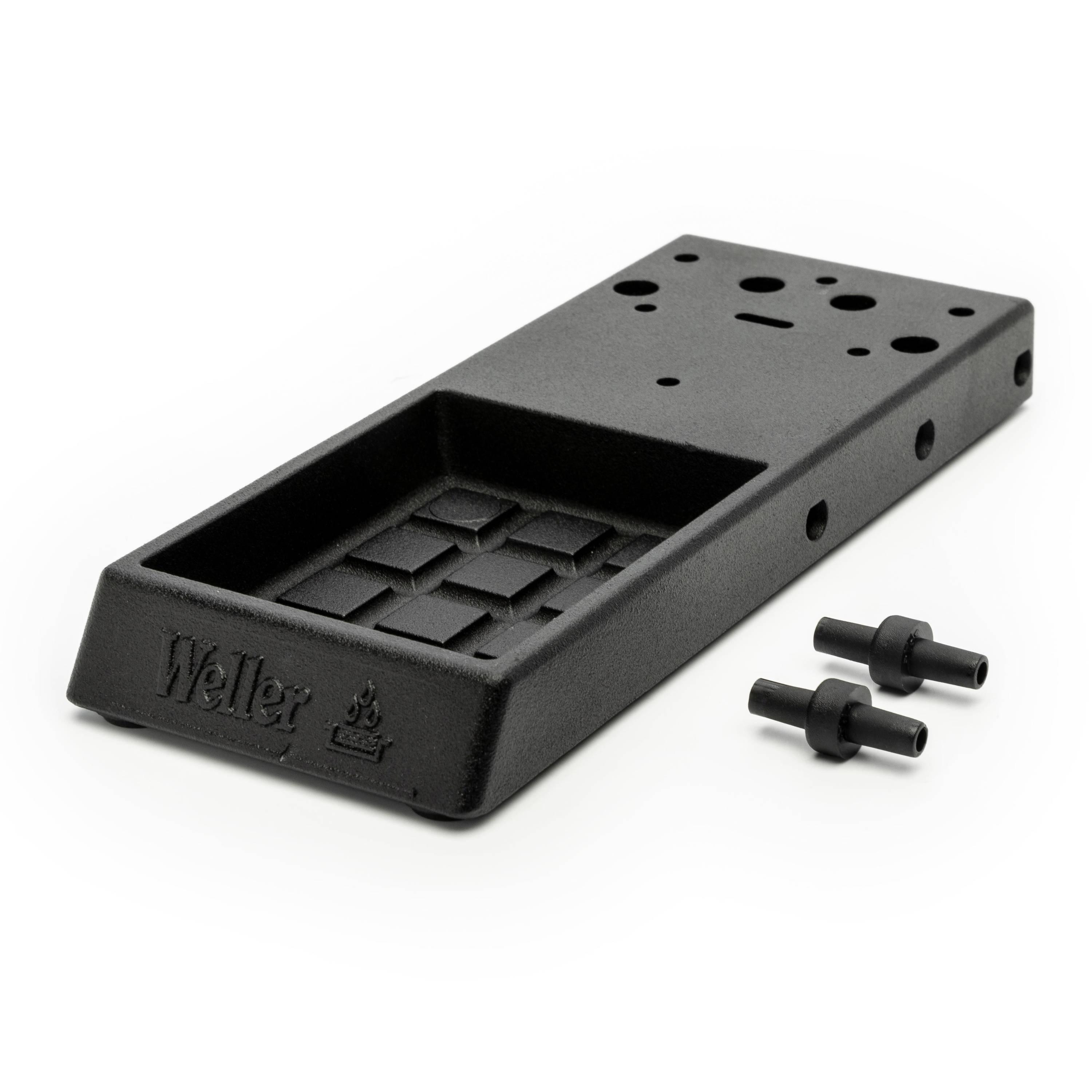 Black Weller soldering iron stand with perforated top and two small black accessory pieces on a white background