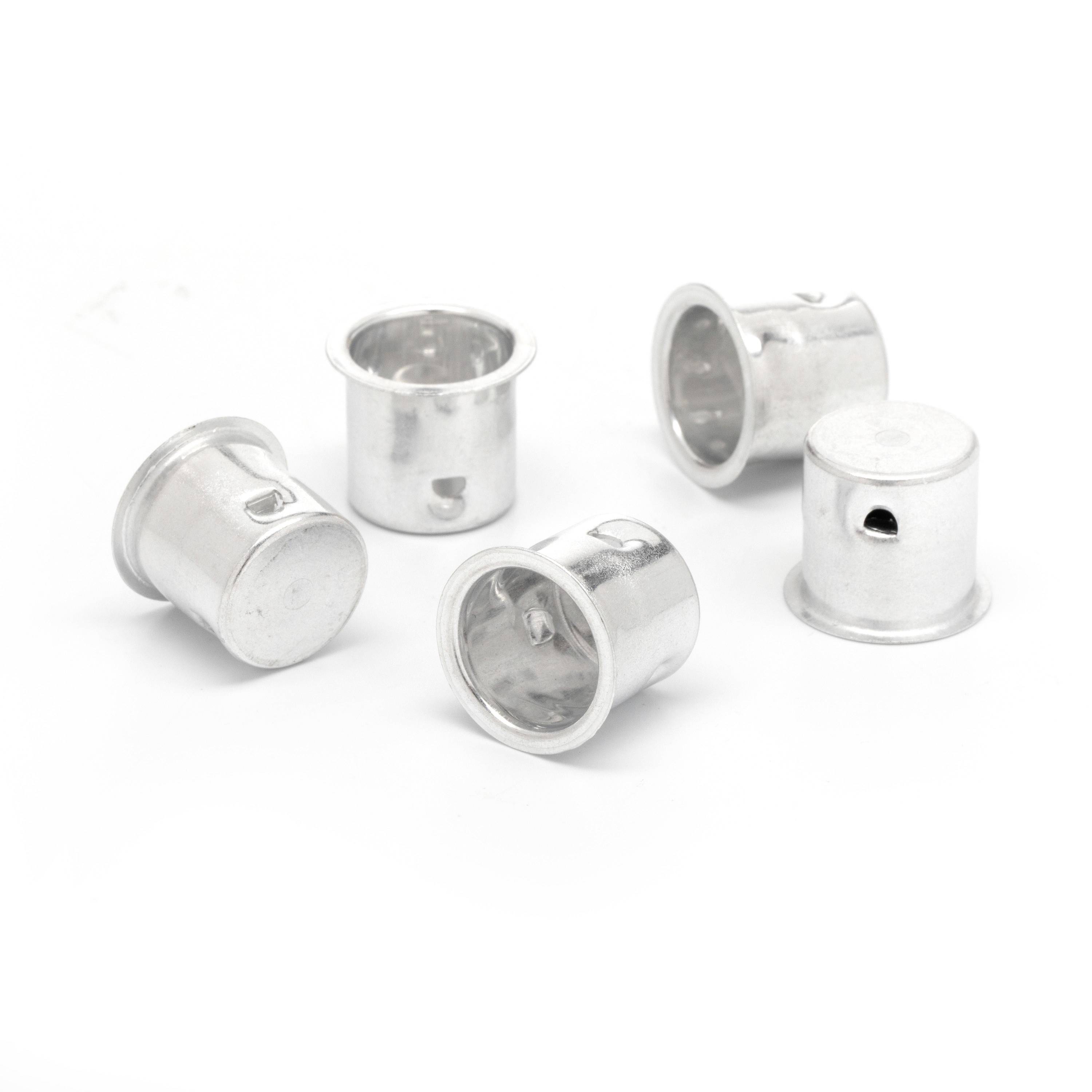 Five small silver metal cylindrical fittings or caps arranged on a white background.