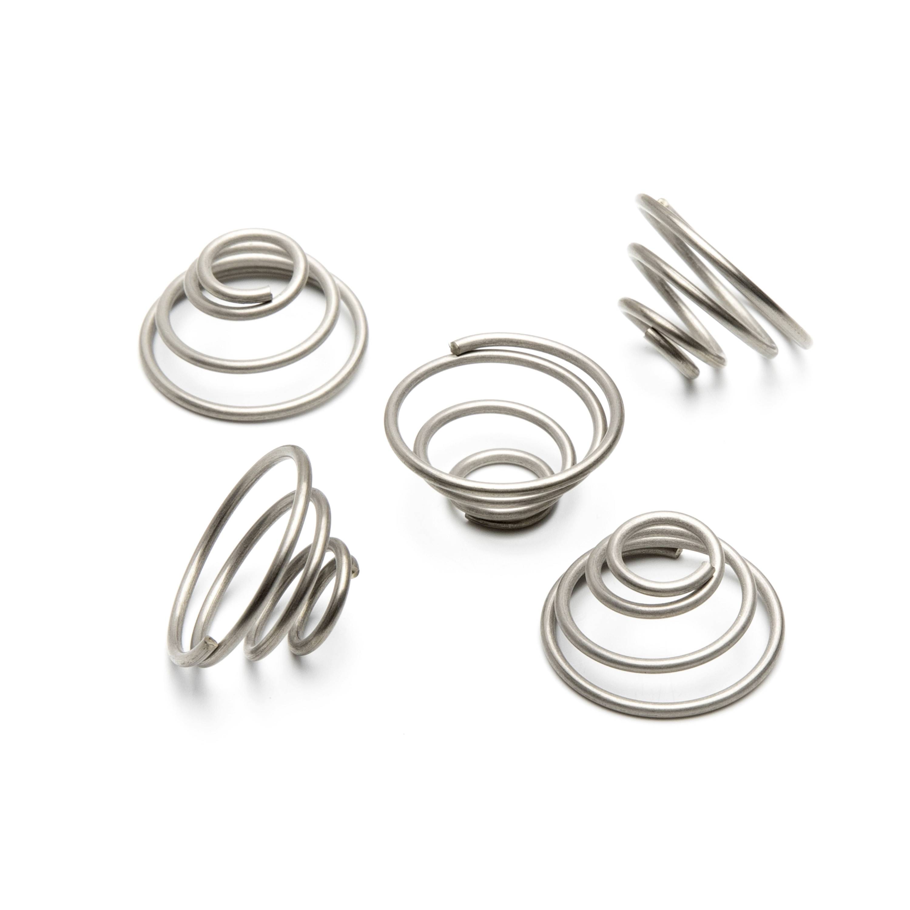 Five metal coil springs arranged on a white background, shown from different angles.