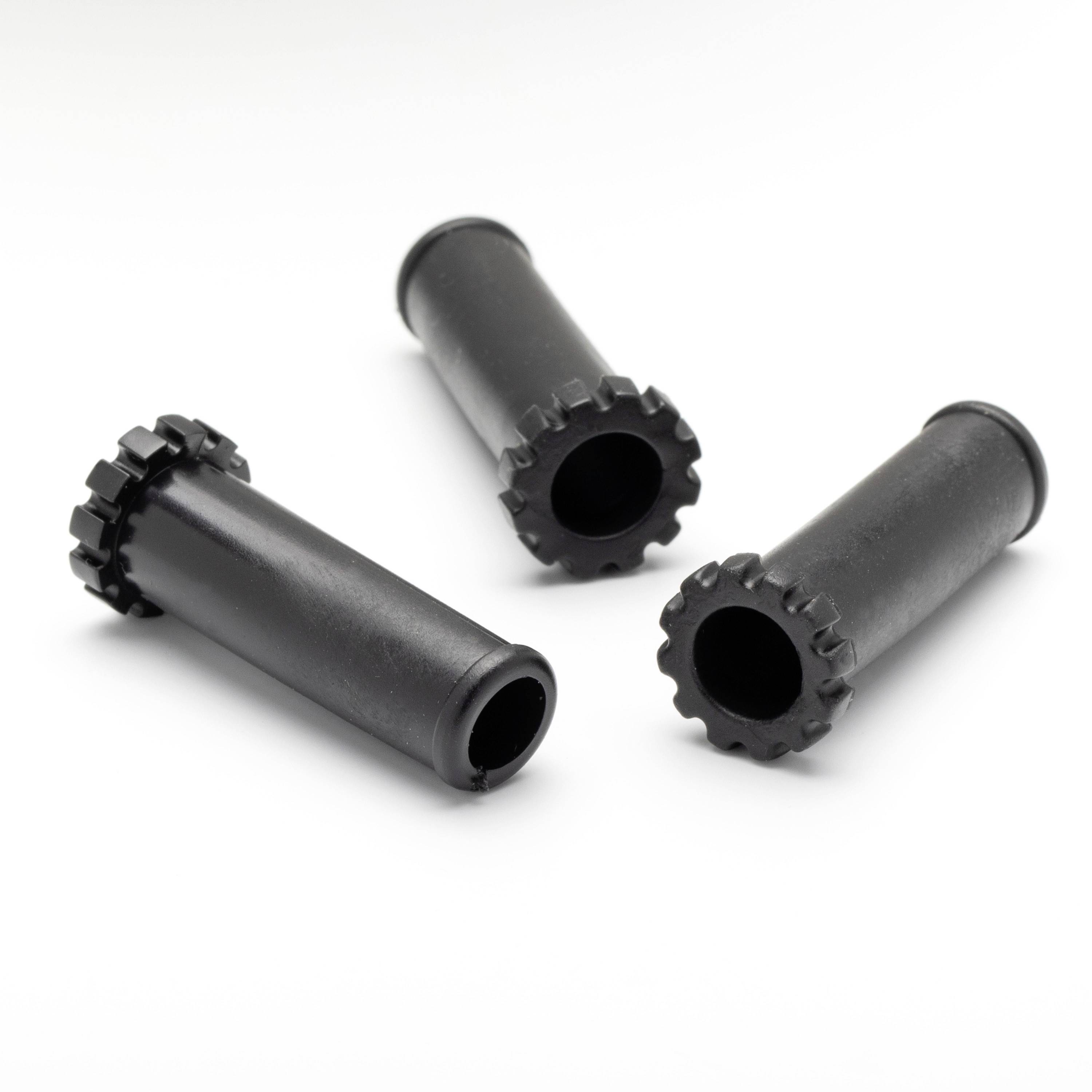 Three black cylindrical plastic connectors with toothed rims arranged on a white background.
