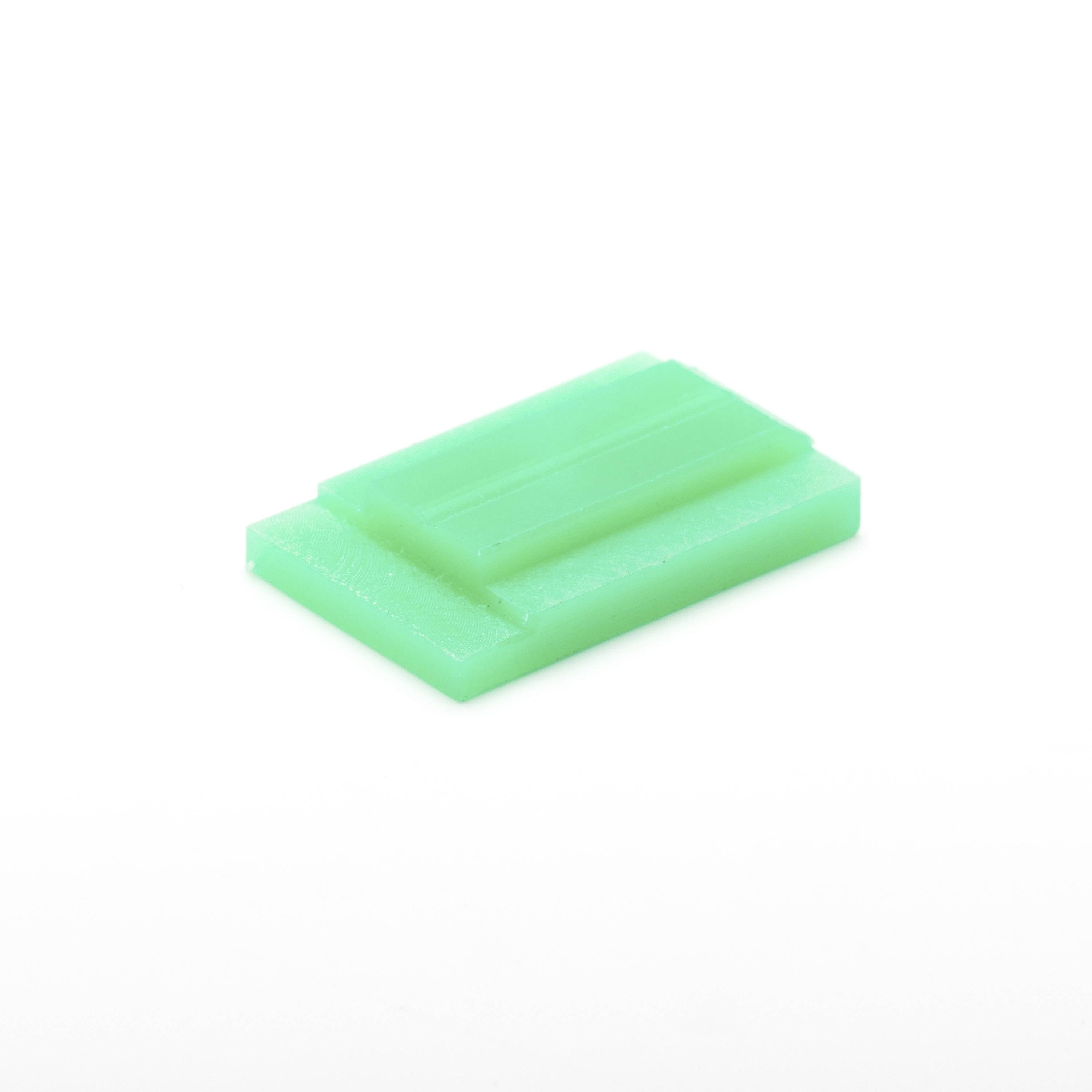 Green rectangular soap bar on a white background.