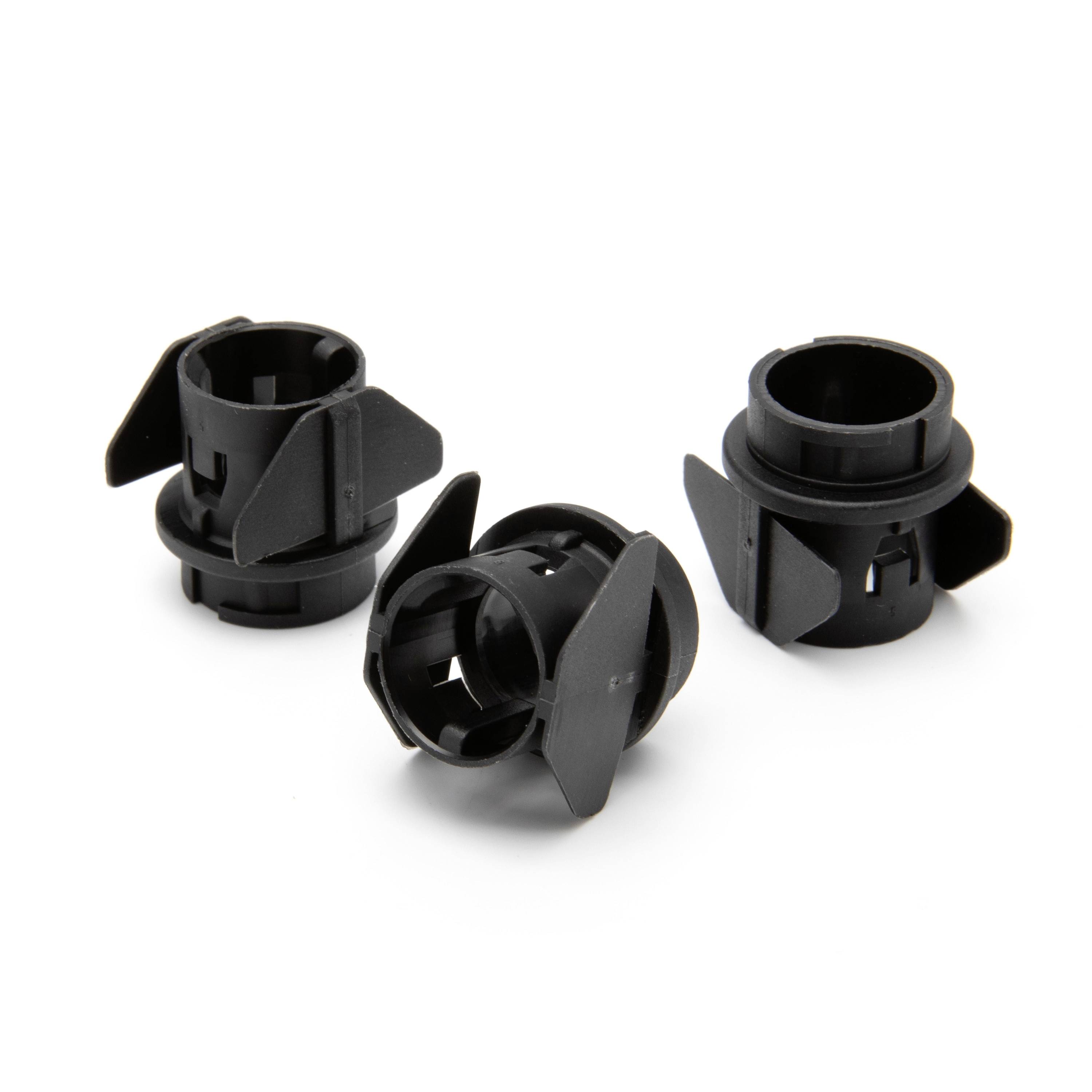 Three black plastic bulb socket holders or connectors shown on a white background, arranged in a small cluster.
