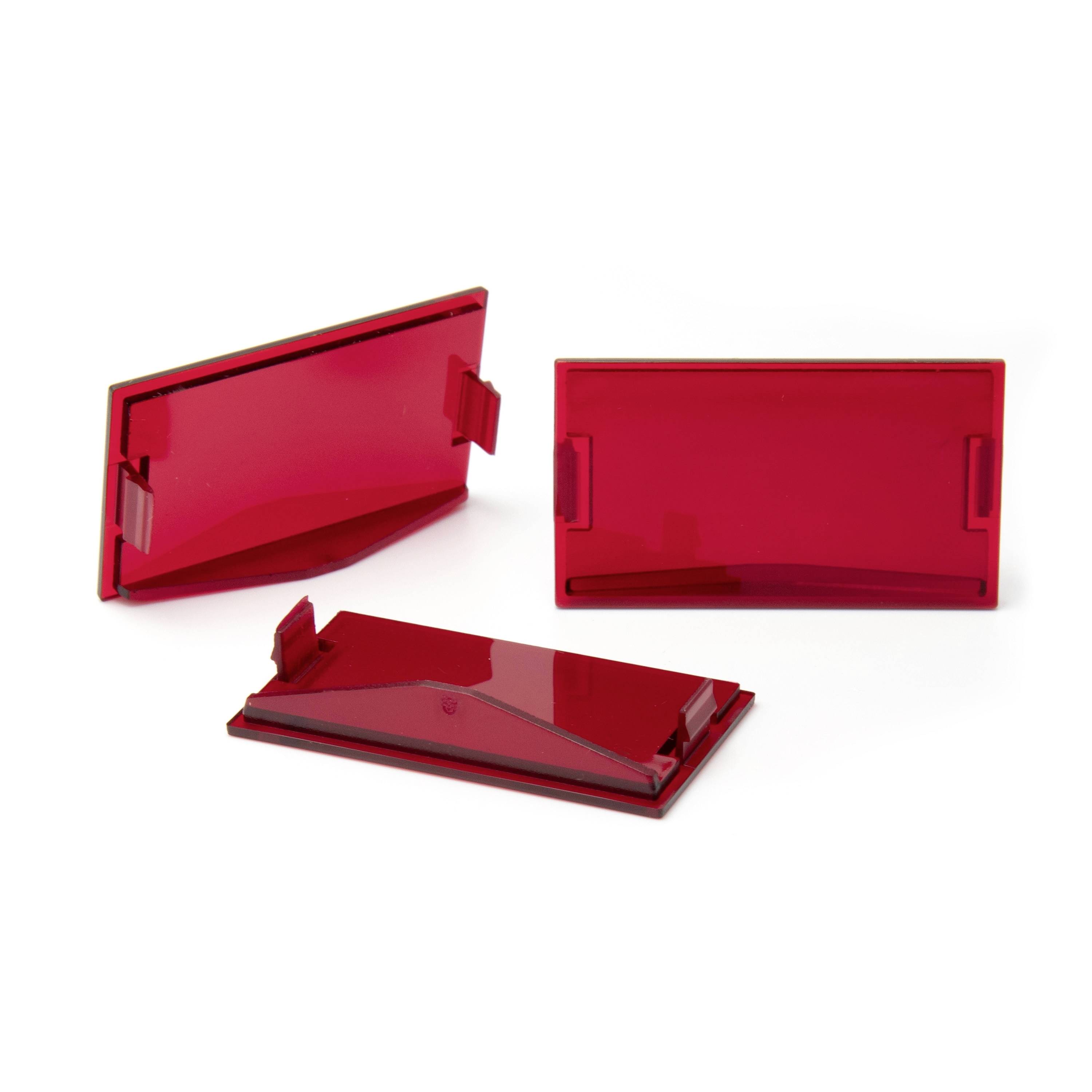 Three translucent red plastic cover panels or lenses, shown in different orientations on a white background.