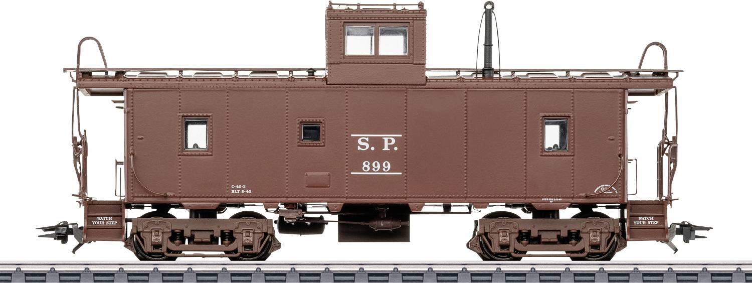 Vue latérale d'un fourgon de queue de train de marchandises marron de style vintage étiqueté « S.P. 899 » sur les rails.