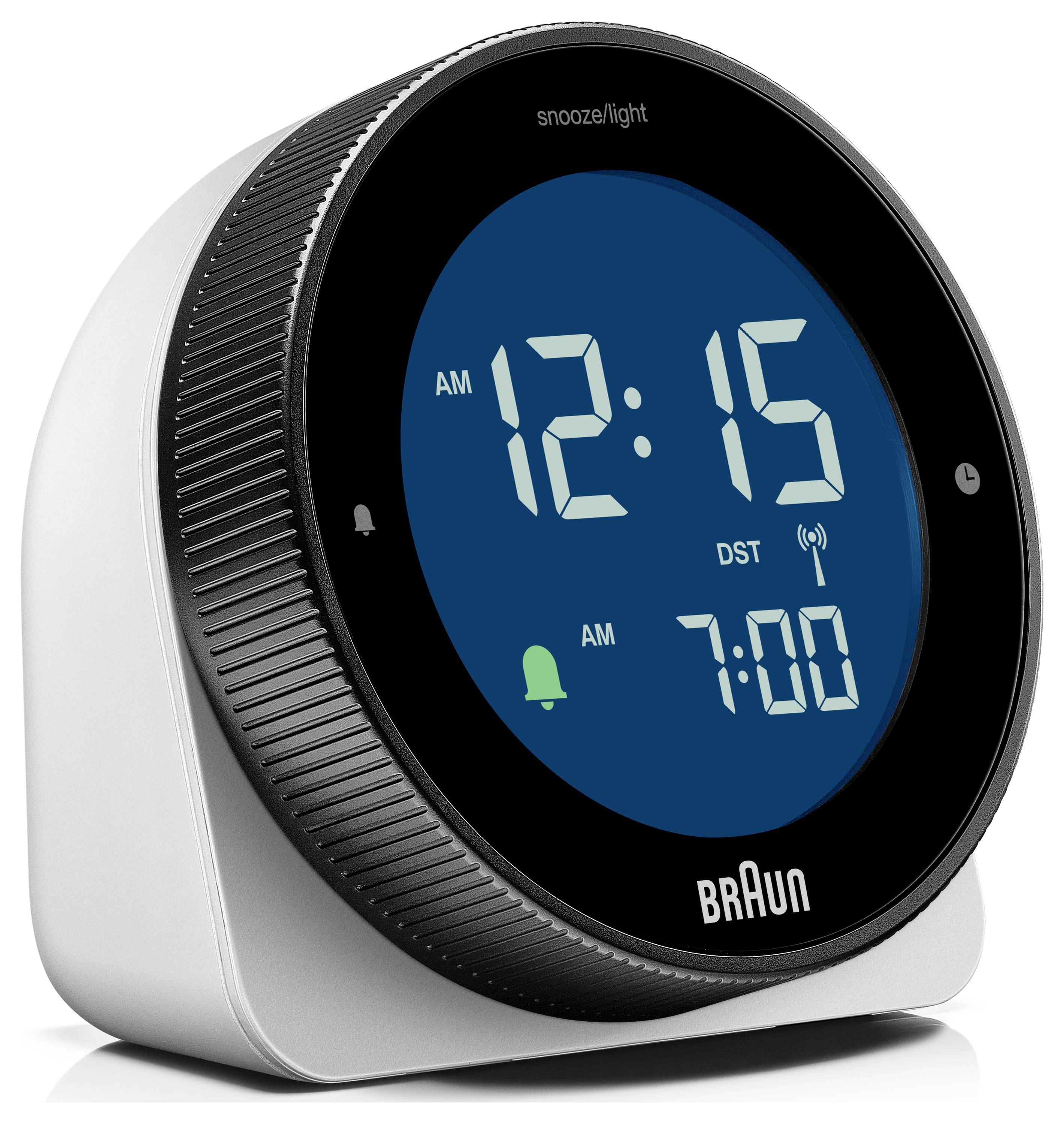 Réveil numérique Braun affichant 12:15 AM et une alarme à 7:00 AM, avec les indicateurs de répétition/lumière et changement d'heure d'été/hiver.