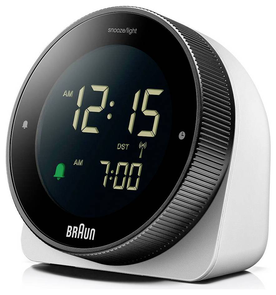 Réveil numérique Braun affichant 12h15 du matin, avec une deuxième alarme réglée sur 7h00 et l'étiquette snooze/lumière sur le cadran.