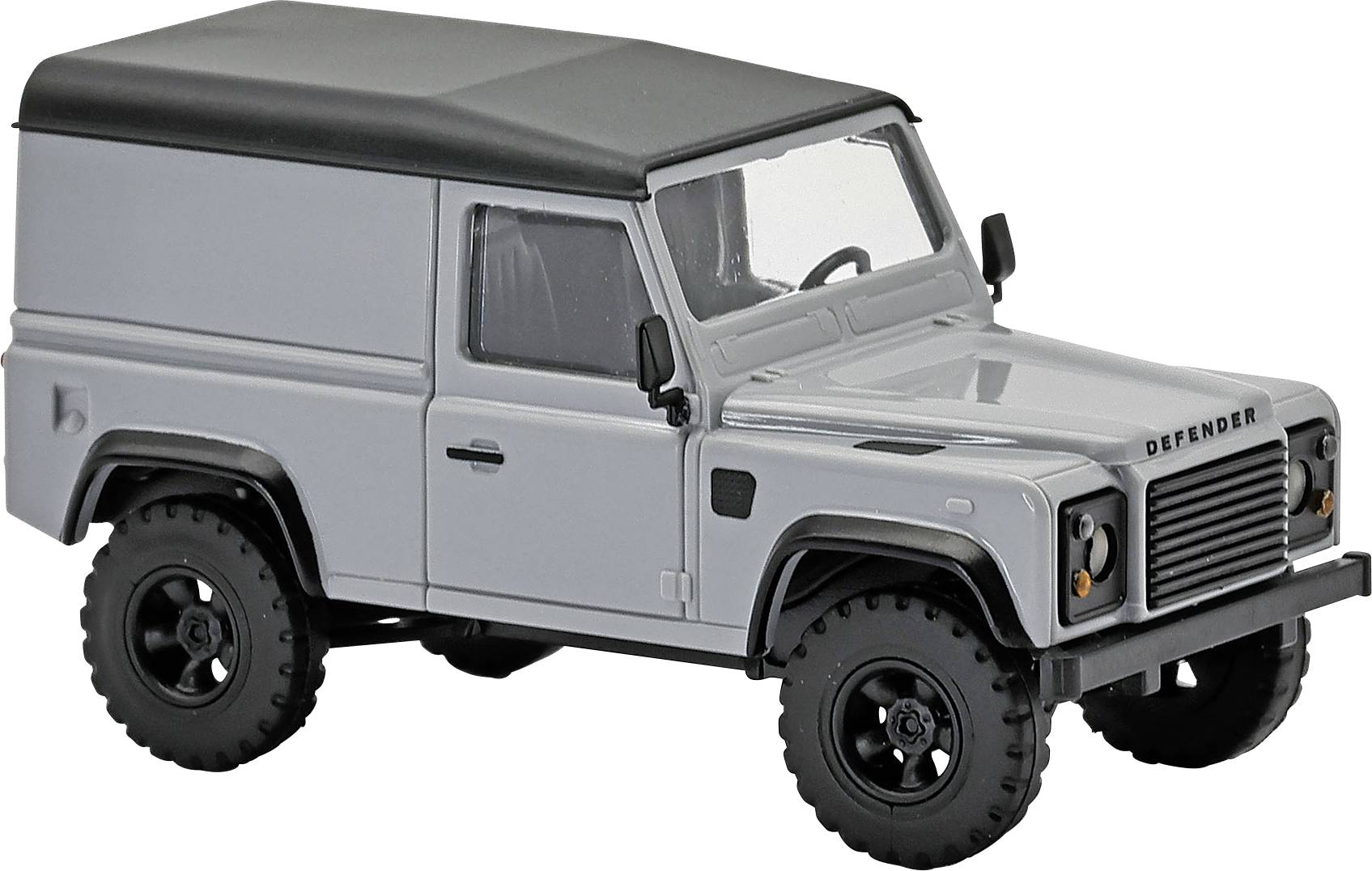 Véhicule utilitaire de style Land Rover Defender gris avec toit noir, présenté en vue latérale sur fond blanc.