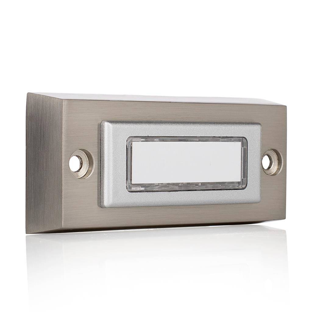Brushed metal wall-mounted doorbell or nameplate with blank rectangular label and round side buttons on a white background.