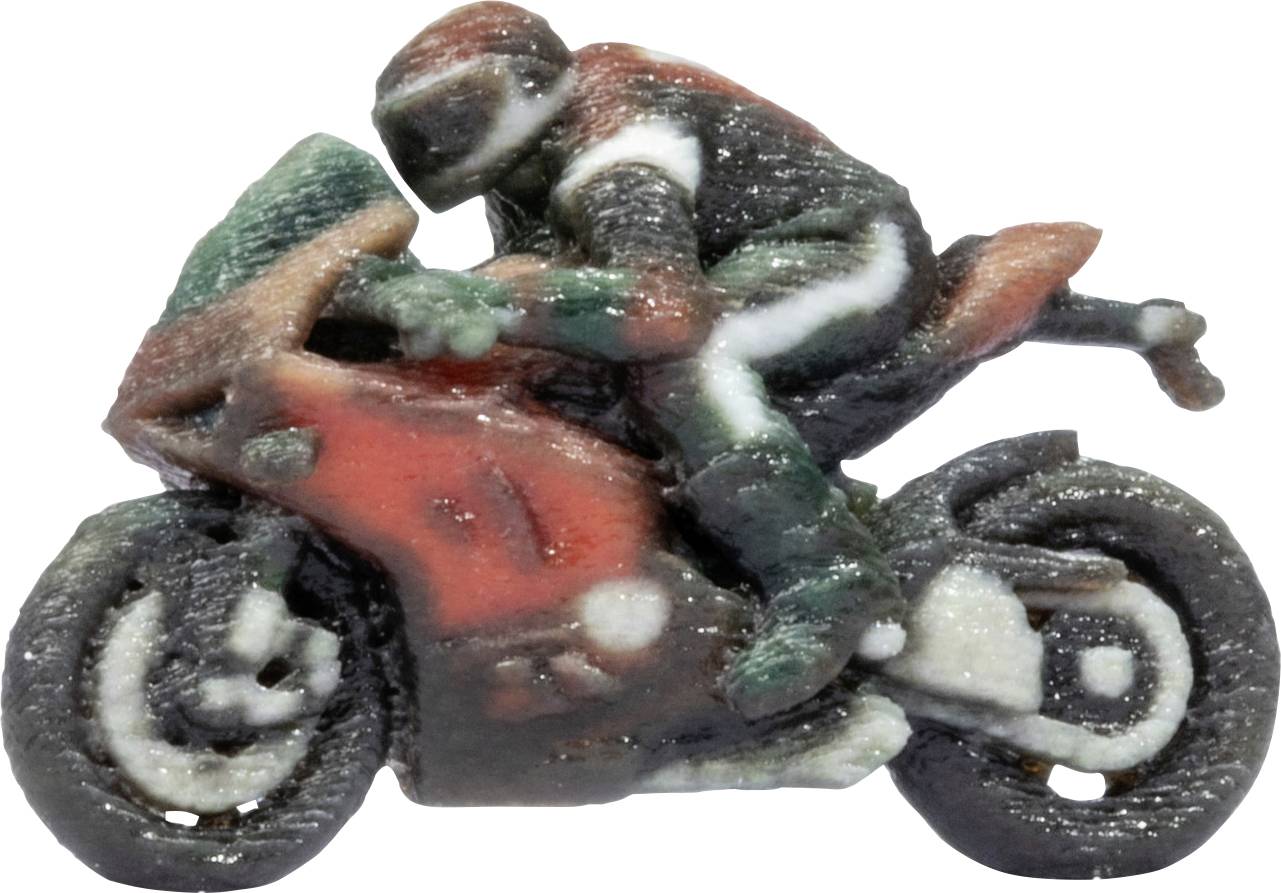 Petite moto jouet avec un pilote penché vers l'avant, peinte en rouge, vert et noir, isolée sur un fond blanc.