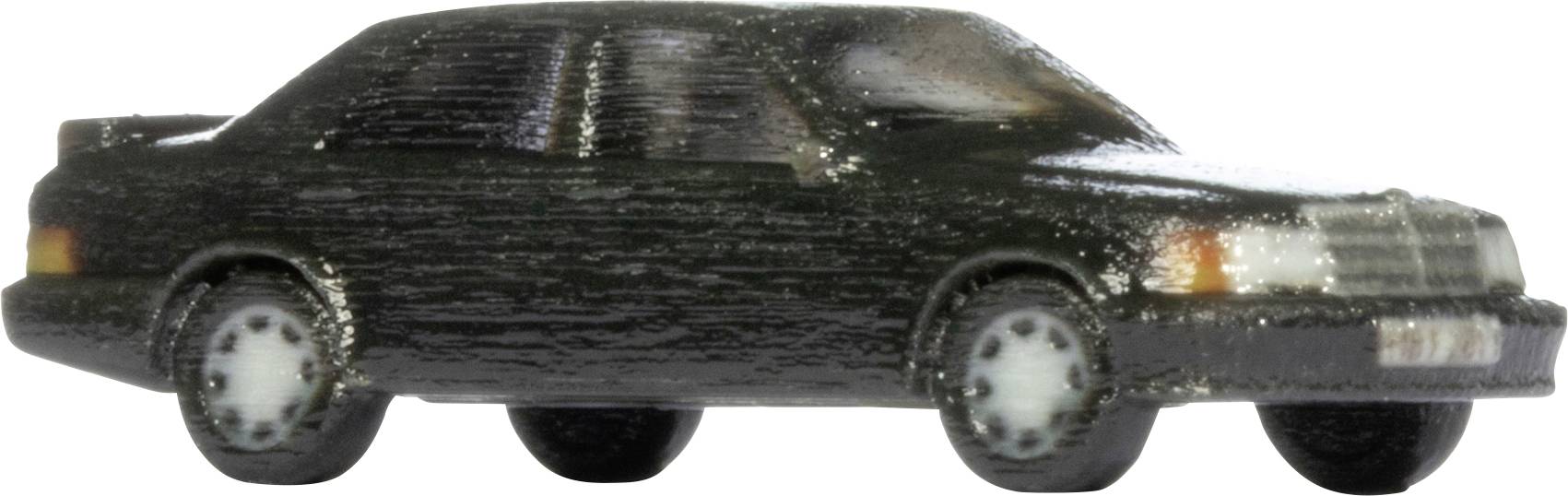 Vue latérale d'une petite voiture de jouet berline noire sur un fond blanc.