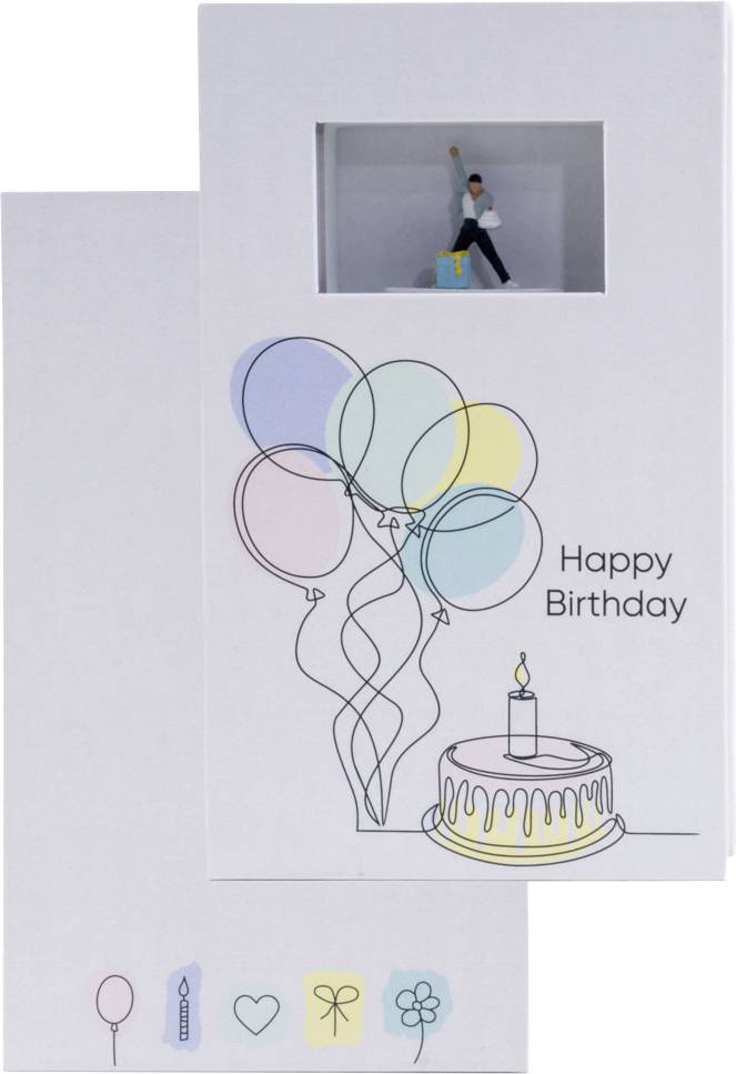 Carte d'anniversaire pop-up blanche avec illustrations de ballons pastel, texte « Joyeux Anniversaire », un petit gâteau et une figurine d'enfant dans la petite fenêtre du haut.