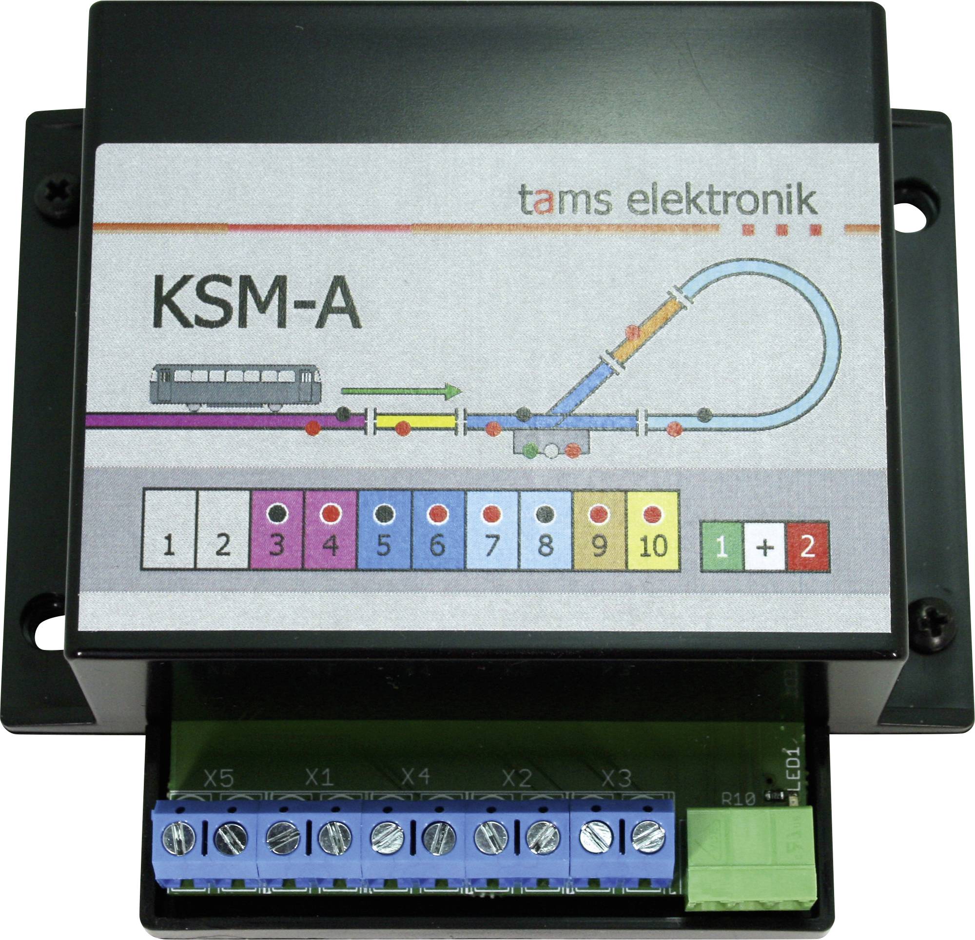 Photo d'un contrôleur de train miniature Tams Elektronik KSM-A avec schéma de voie étiqueté, boutons de sortie numérotés et connexions à bornes à vis.