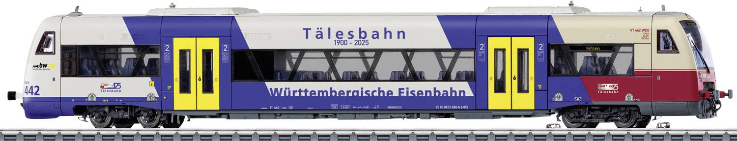 Vue latérale d'un train de voyageurs Talgo en livrée bleue, blanche et rouge avec des portes jaunes, étiqueté « Tålesbahn » et « Württembergische Eisenbahn ».